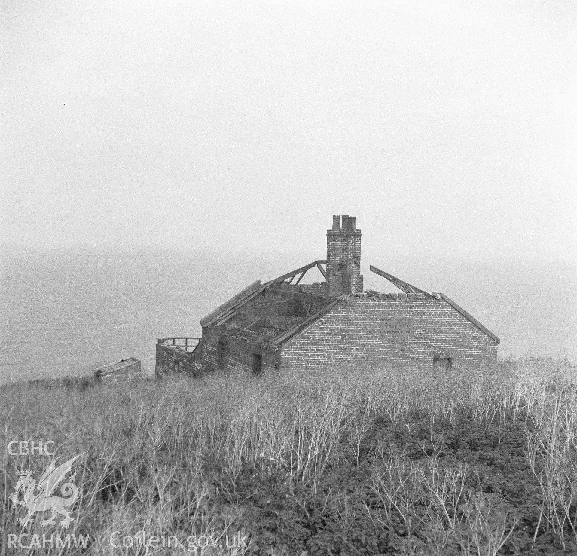 Digital copy of a black and white negative showing a roofless house on Puffin Island