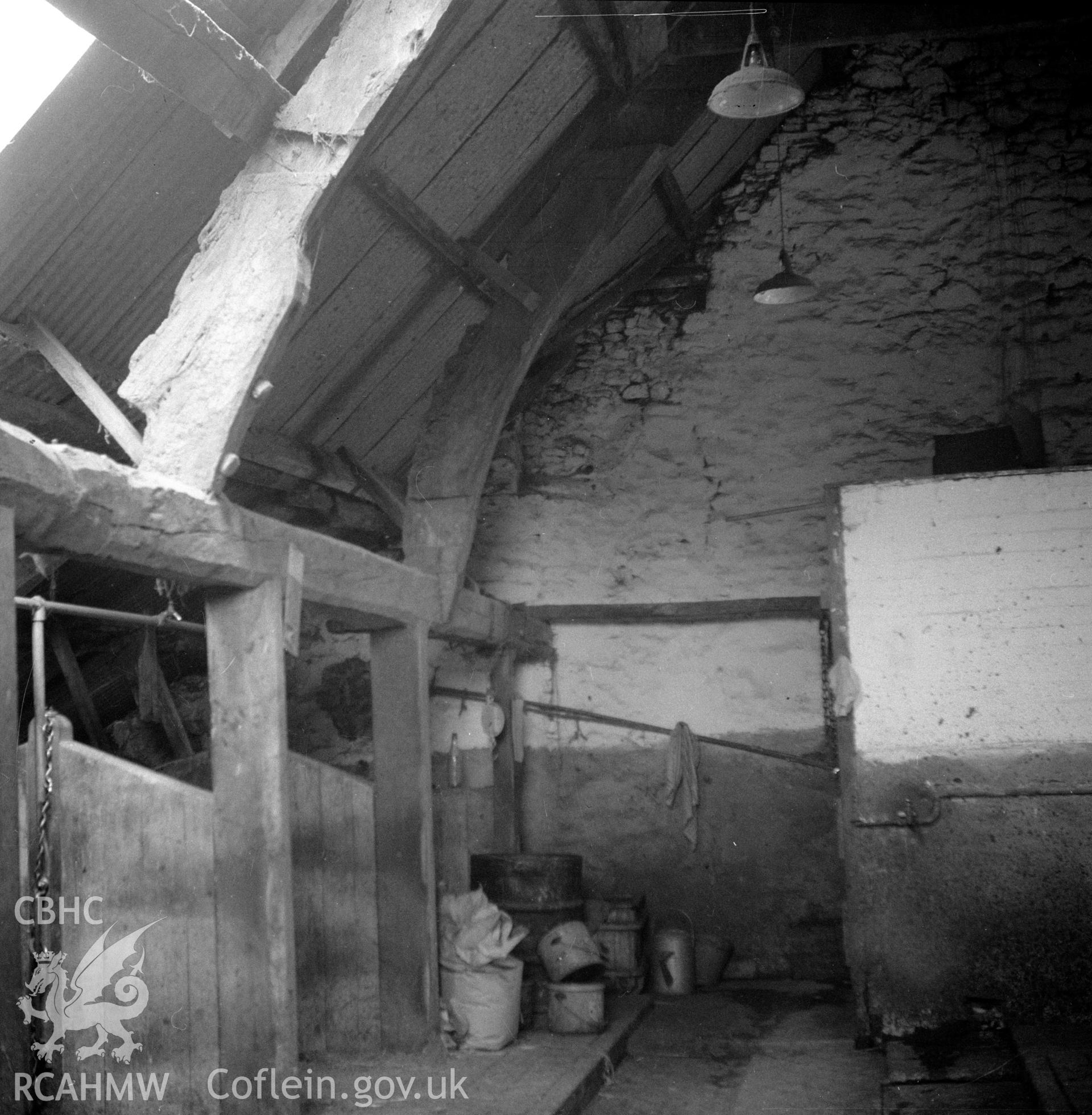 Digital copy of a nitrate negative showing interior view of cruck barn at Maes y Rhiw, Llansadwrn.