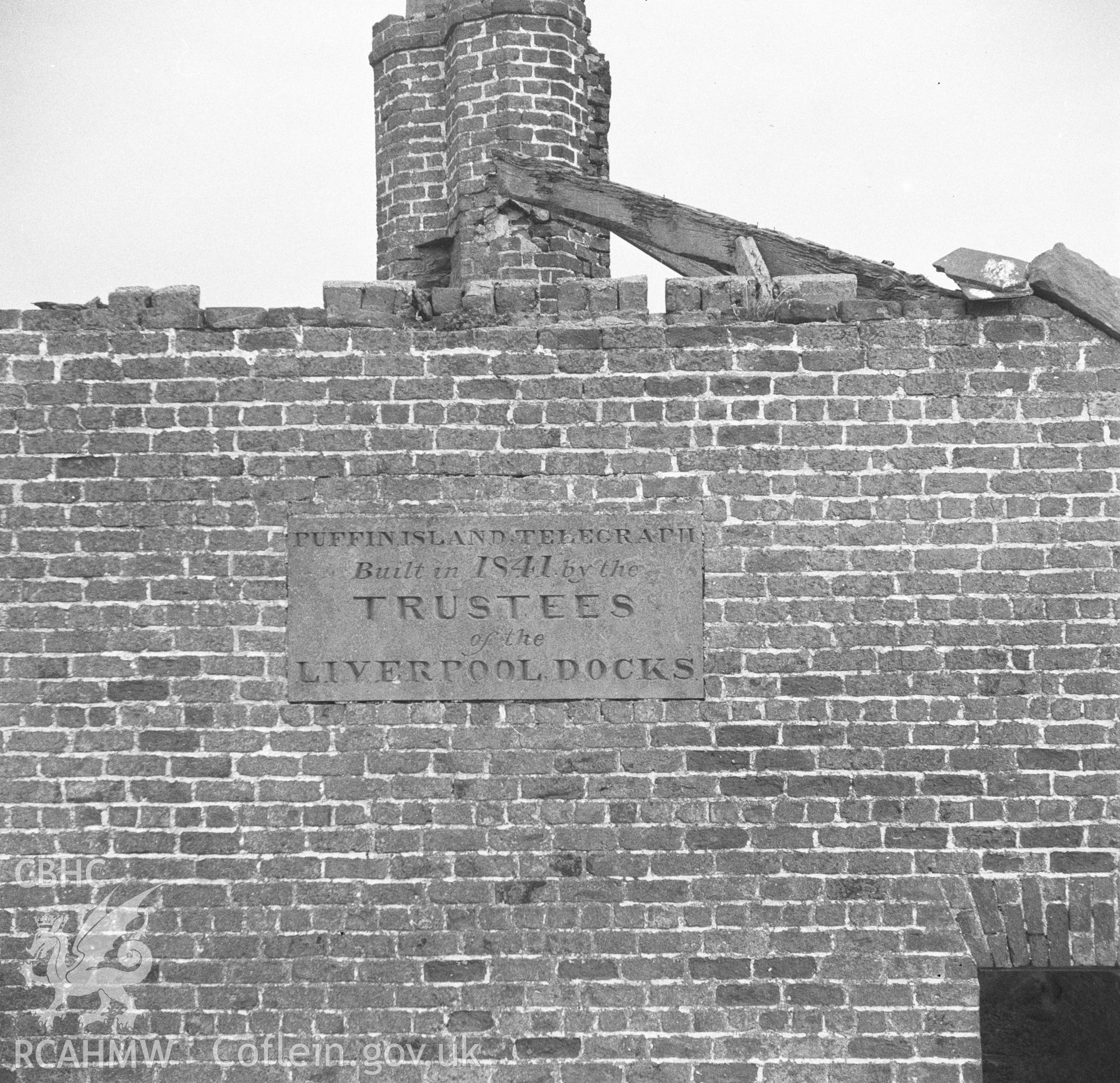 Digital copy of a black and white negative showing plaque on the Telegraph Building, Puffin Island.