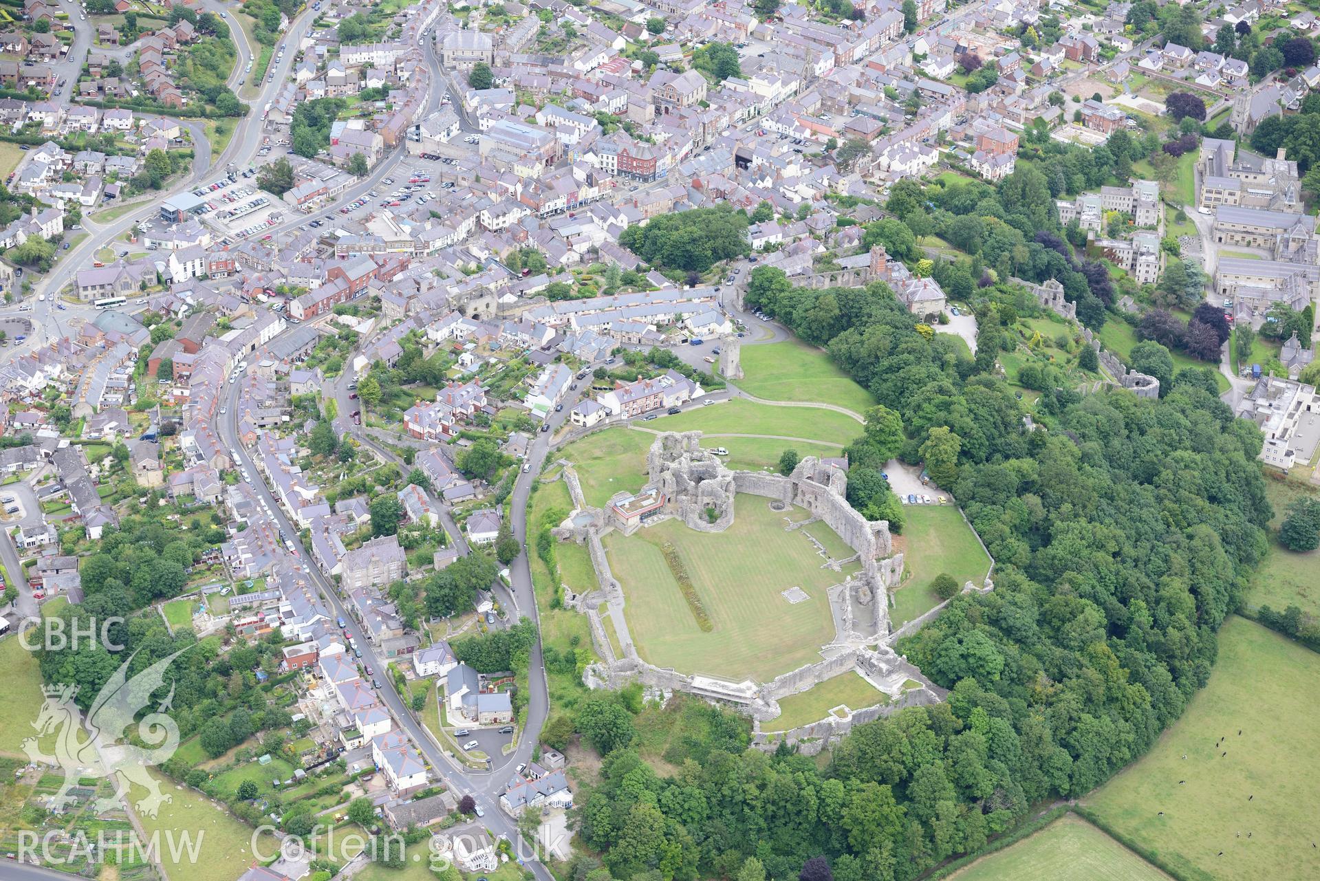 Town walls, Denbigh Castle, Castle House, CADW visitor centre, the Goblin Tower and Howell's School. Oblique aerial photograph taken during the Royal Commission's programme of archaeological aerial reconnaissance by Toby Driver on 30th July 2015.