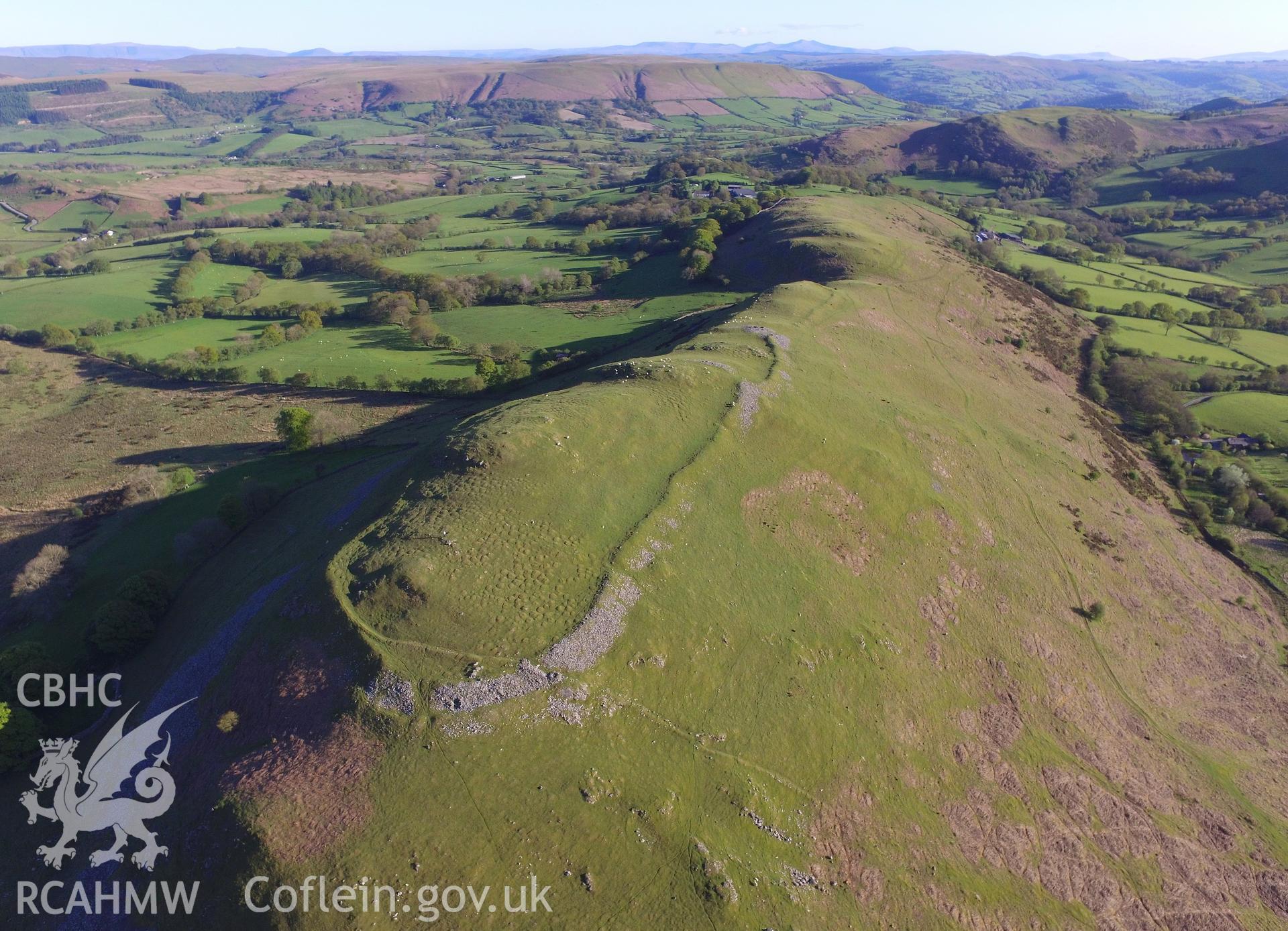 Colour photo showing aerial view of Castle Bank hillfort, Glasgwm, taken by Paul R. Davis, 13th May 2018.