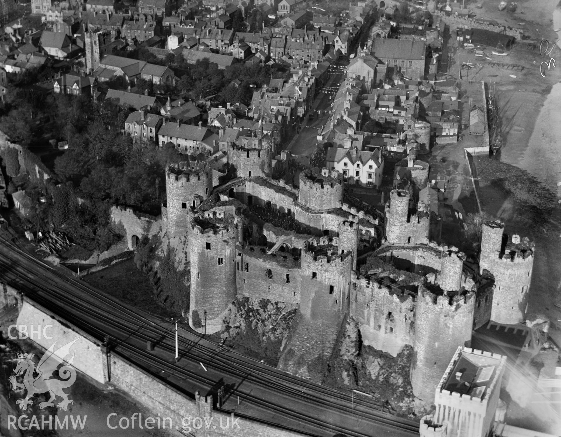 General view of Conwy showing castle during the event of the presentation of a silver box to David Lloyd George by the town of Conwy, 1923, oblique aerial view. 5?x4? black and white glass plate negative.