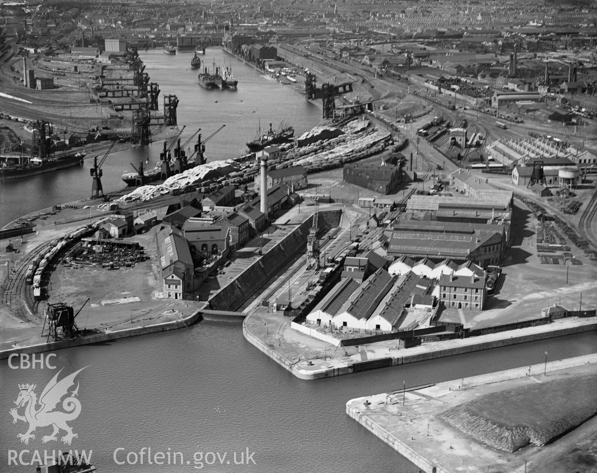Black and white oblique aerial photograph showing the docks at Cardiff, from Aerofilms album Cardiff (W22), taken by Aerofilms Ltd and dated 1934.