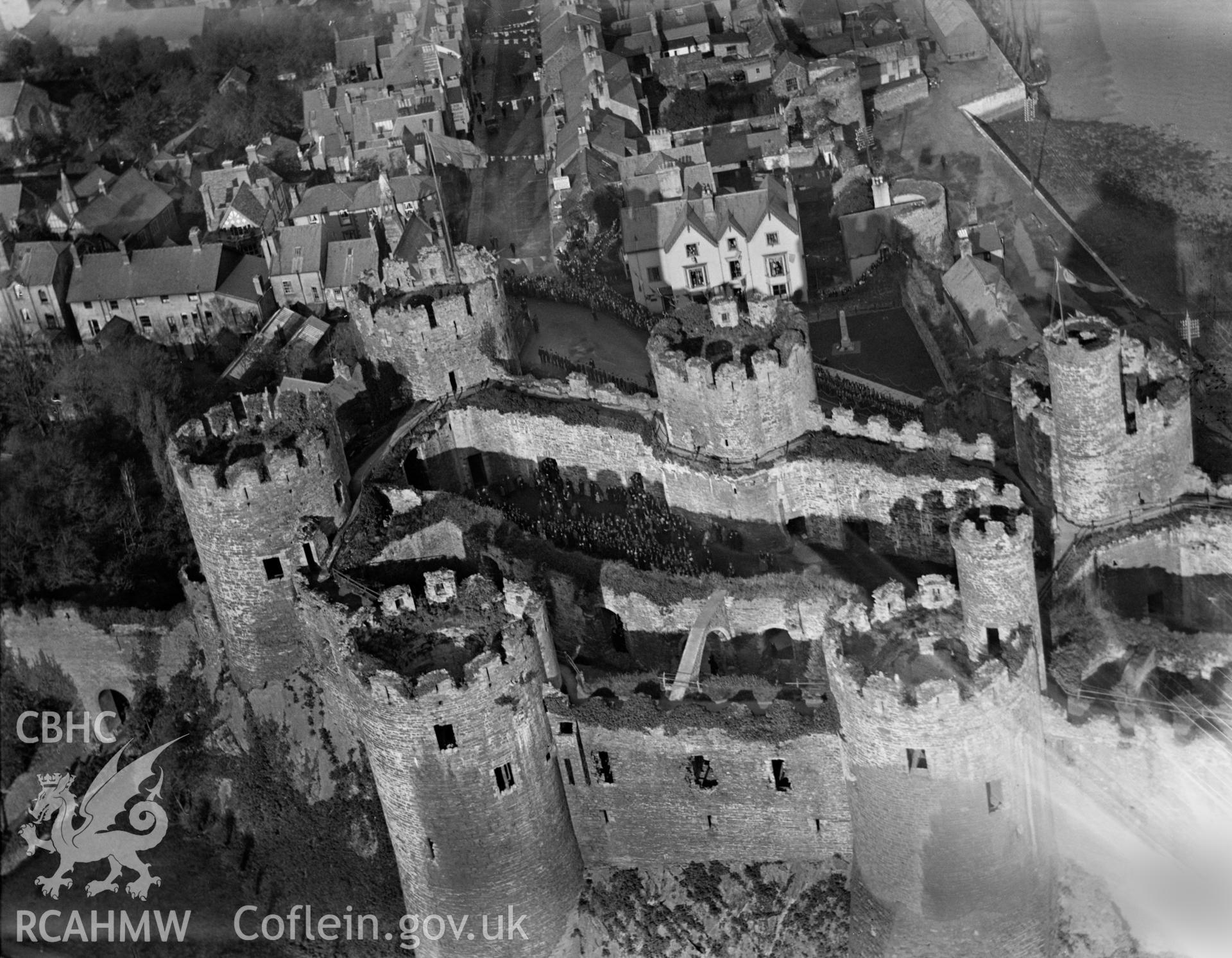 General view of Conwy showing castle during the event of the presentation of a silver box to David Lloyd George by the town of Conwy, 1923, oblique aerial view. 5?x4? black and white glass plate negative.