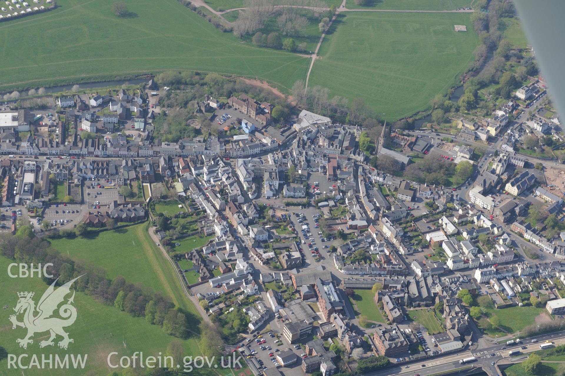 Monmouth including views of the caste; castle house; market hall; common; St Mary the Virgin church and Baptist chapel. Oblique aerial photograph taken during the Royal Commission's programme of archaeological aerial reconnaissance by Toby Driver on 15th April 2015.