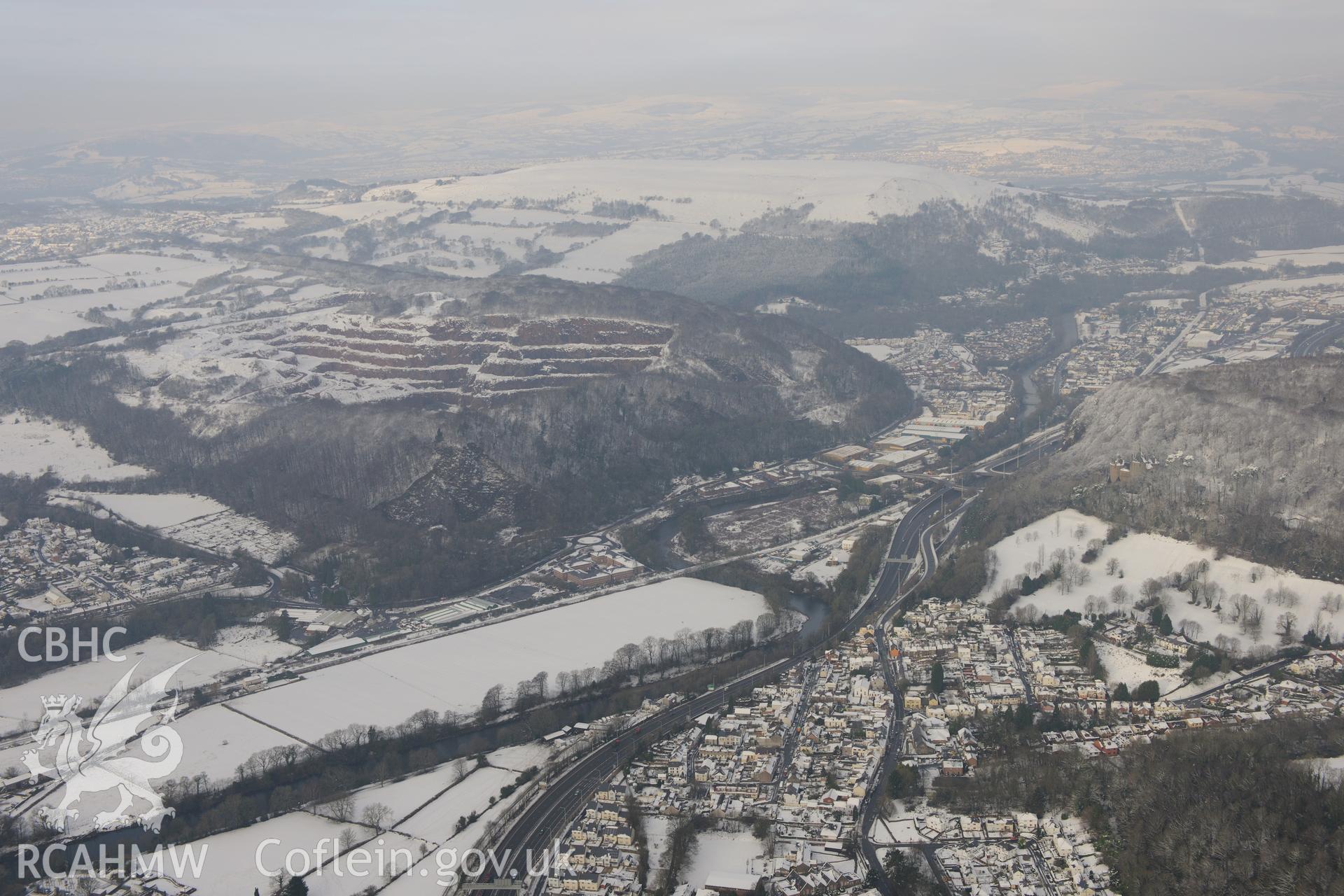 Castell Coch and Taff's Well Quarry, rising above Tongwynlais and the river Taff. Oblique aerial photograph taken during the Royal Commission?s programme of archaeological aerial reconnaissance by Toby Driver on 24th January 2013.