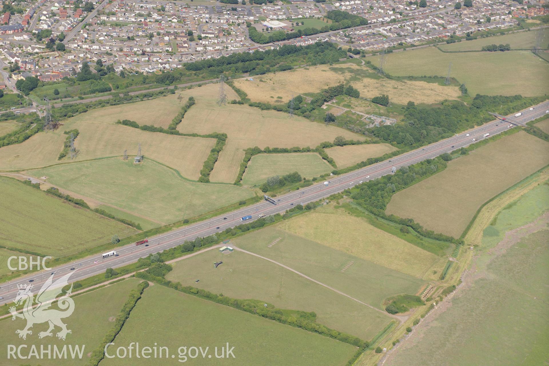 Caldicot level ridge & furrow, rifle range & M4 motorway section passing southern edge of Caldicot on way to 2nd Severn Crossing. Oblique aerial photograph taken during RCAHMW?s programme of archaeological aerial reconnaissance by Toby Driver 01/08/2013.
