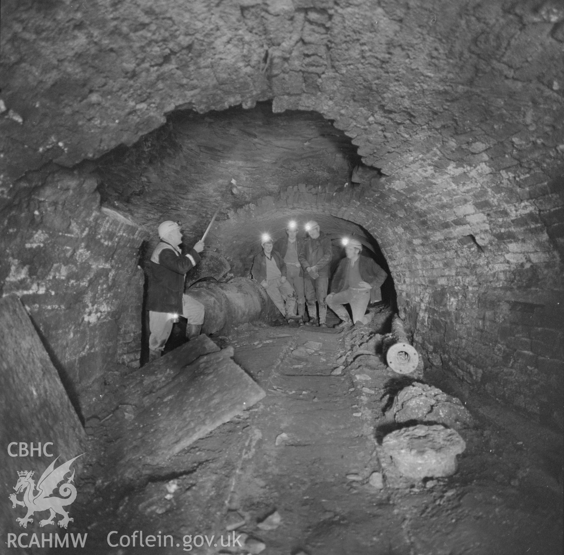 Digital copy of an acetate negative showing workmen inspecting old roadway nr. Coity Pits at Big Pit, from the John Cornwell Collection.