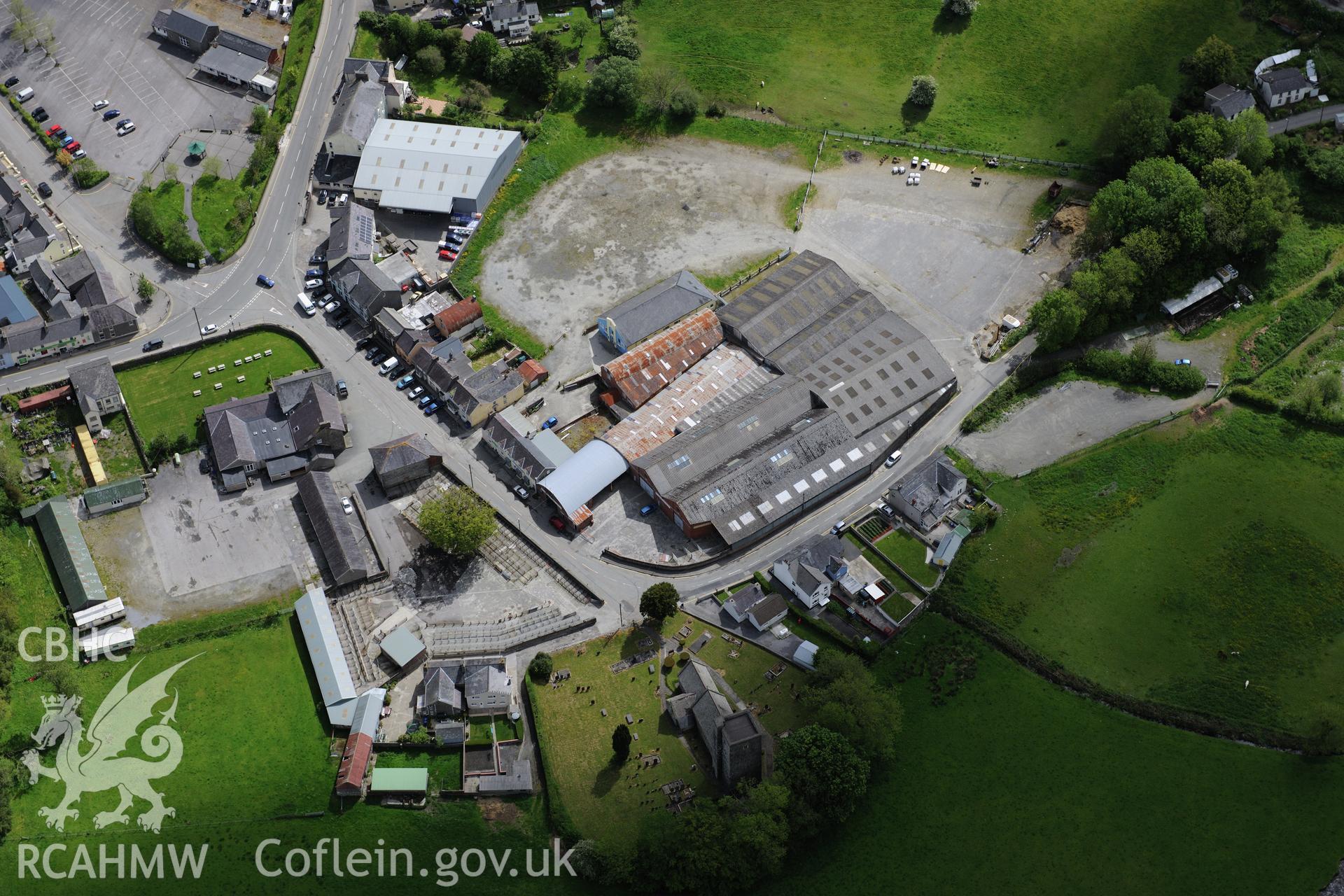 St. Peter's Church and Llanybydder Livestock Market at Llanybydder. Oblique aerial photograph taken during the Royal Commission's programme of archaeological aerial reconnaissance by Toby Driver on 3rd June 2015.