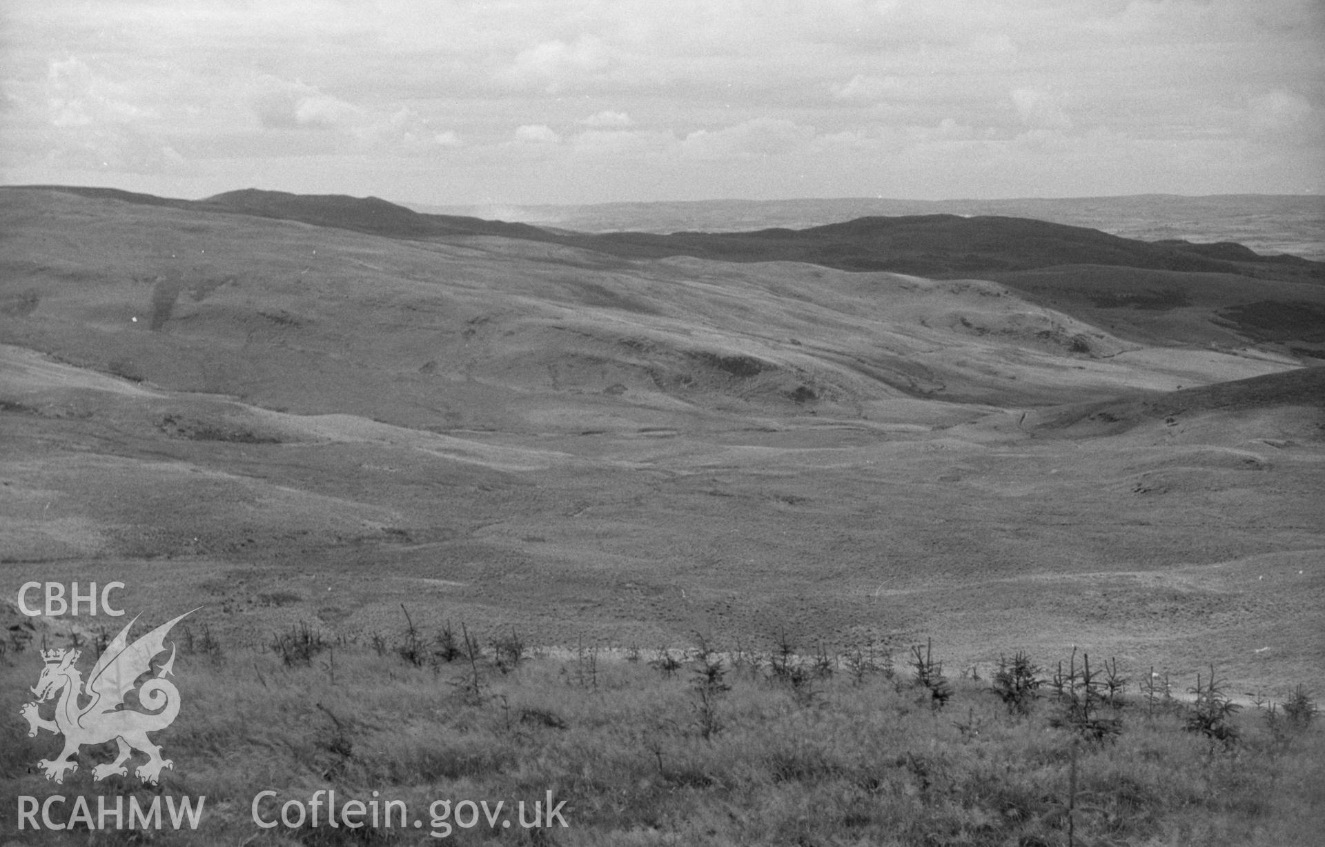 Digital copy of a black and white negative showing view down the Glasffrwd valley to Strata Florida and Pontrhydfendigaid. Photographed by Arthur O. Chater on 30th August 1965 from Grid Reference SN 779 627, looking north west.