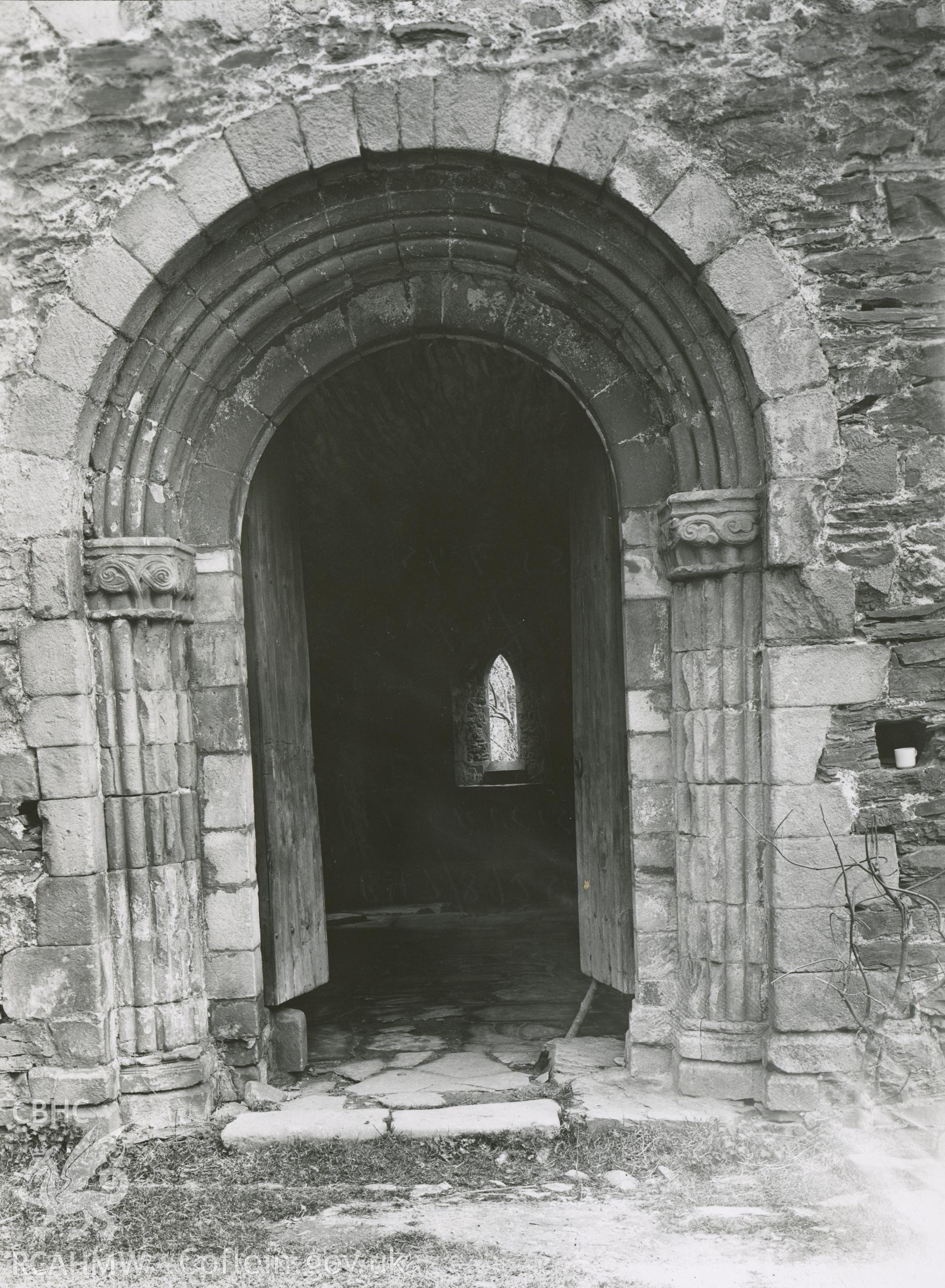 Digitised copy of a black and white photograph showing door to sacristy on east side of cloister at Valle Crucis Abbey, taken by F.H. Crossley, 1949. Copied from print as negative held by NMR England (Historic England)