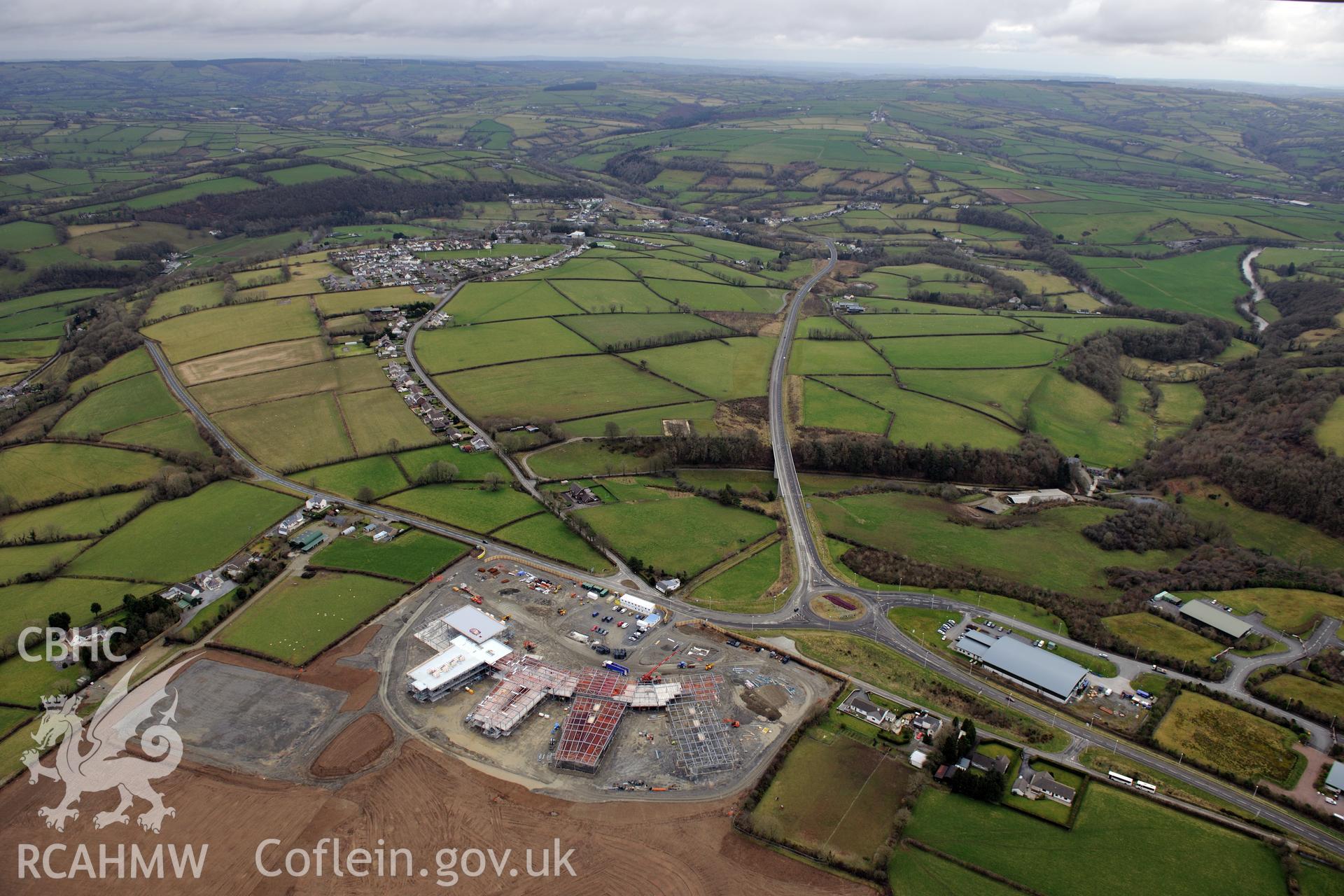 Ysgol Bro Teifi under construction, the A486 Llandysul bypass, and the town of Llandysul beyond. Oblique aerial photograph taken during the Royal Commission's programme of archaeological aerial reconnaissance by Toby Driver on 13th March 2015.