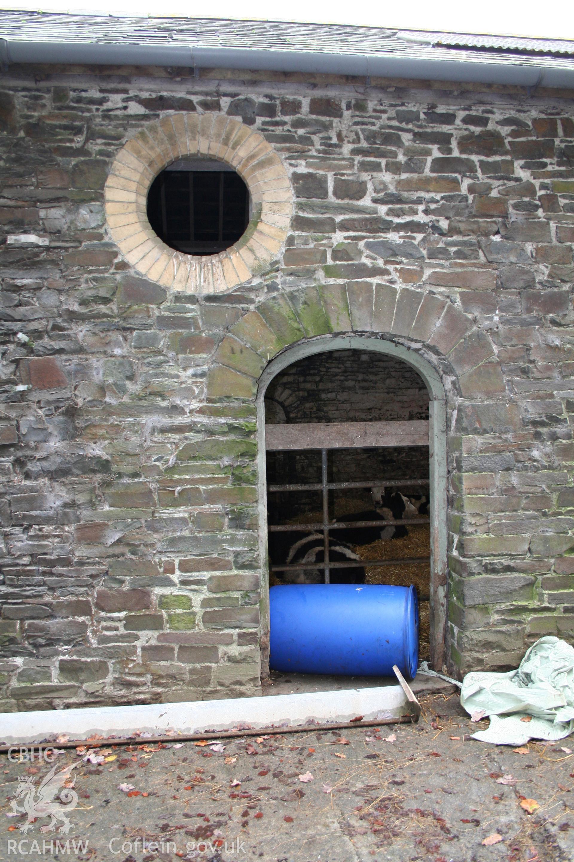 Exterior view of cattle shelter showing stone wall, brick archway and window circle. Photographic survey of the exterior of the farm buildings at Tan-y-Graig Farm, Llanfarian, Aberystwyth. Conducted by Geoff Ward and John Wiles, 11th December 2006.