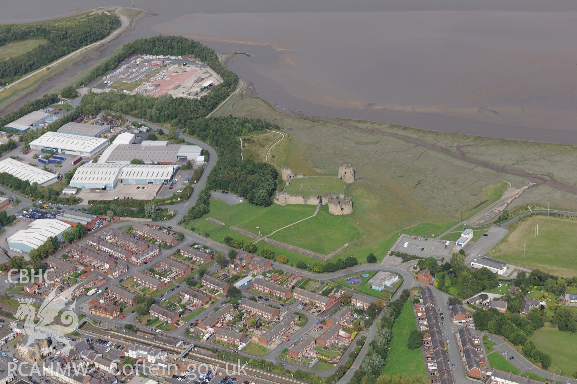 Ashmount Centre (formerly an alkali works, then a textile factory) and Flint Castle, Flint. Oblique aerial photograph taken during the Royal Commission's programme of archaeological aerial reconnaissance by Toby Driver on 11th September 2015.