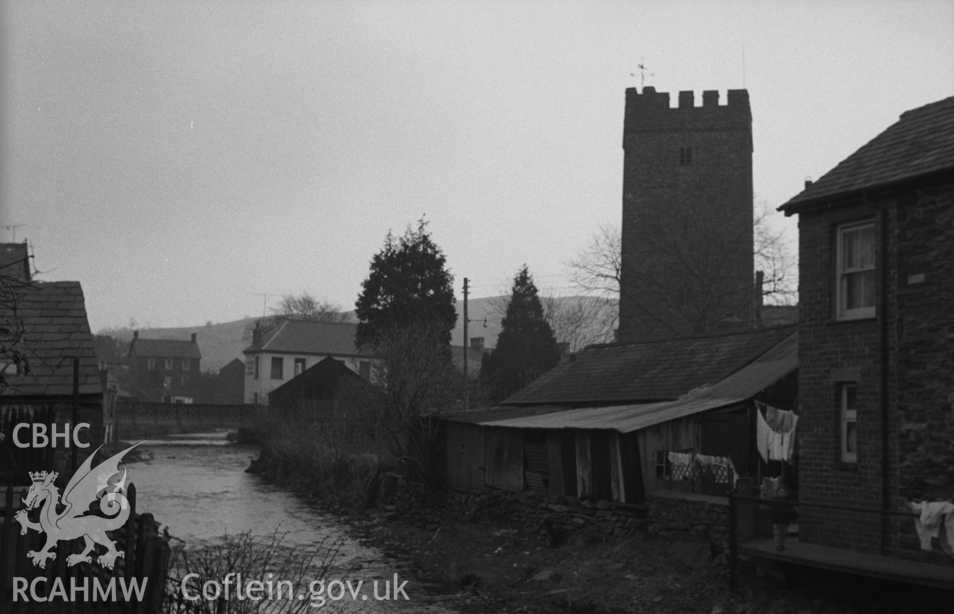 Digital copy of black & white negative showing the church from the footbridge across the Afon Brennig. Photographed in April 1963 by Arthur O. Chater from Grid Reference SN 6791 5964, looking north east.