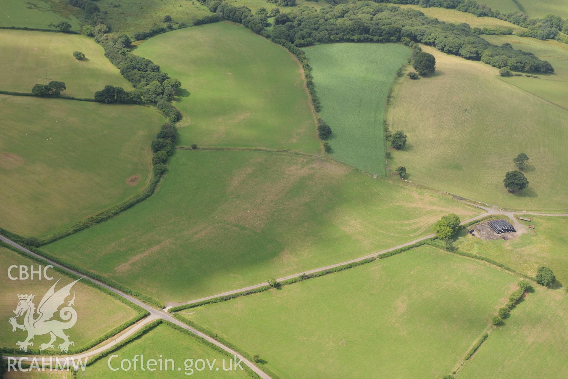 Cropmarks of Roman camp west of Caerau Roman fort, Beulah, west of Builth Wells. Oblique aerial photograph taken during the Royal Commission?s programme of archaeological aerial reconnaissance by Toby Driver on 1st August 2013.