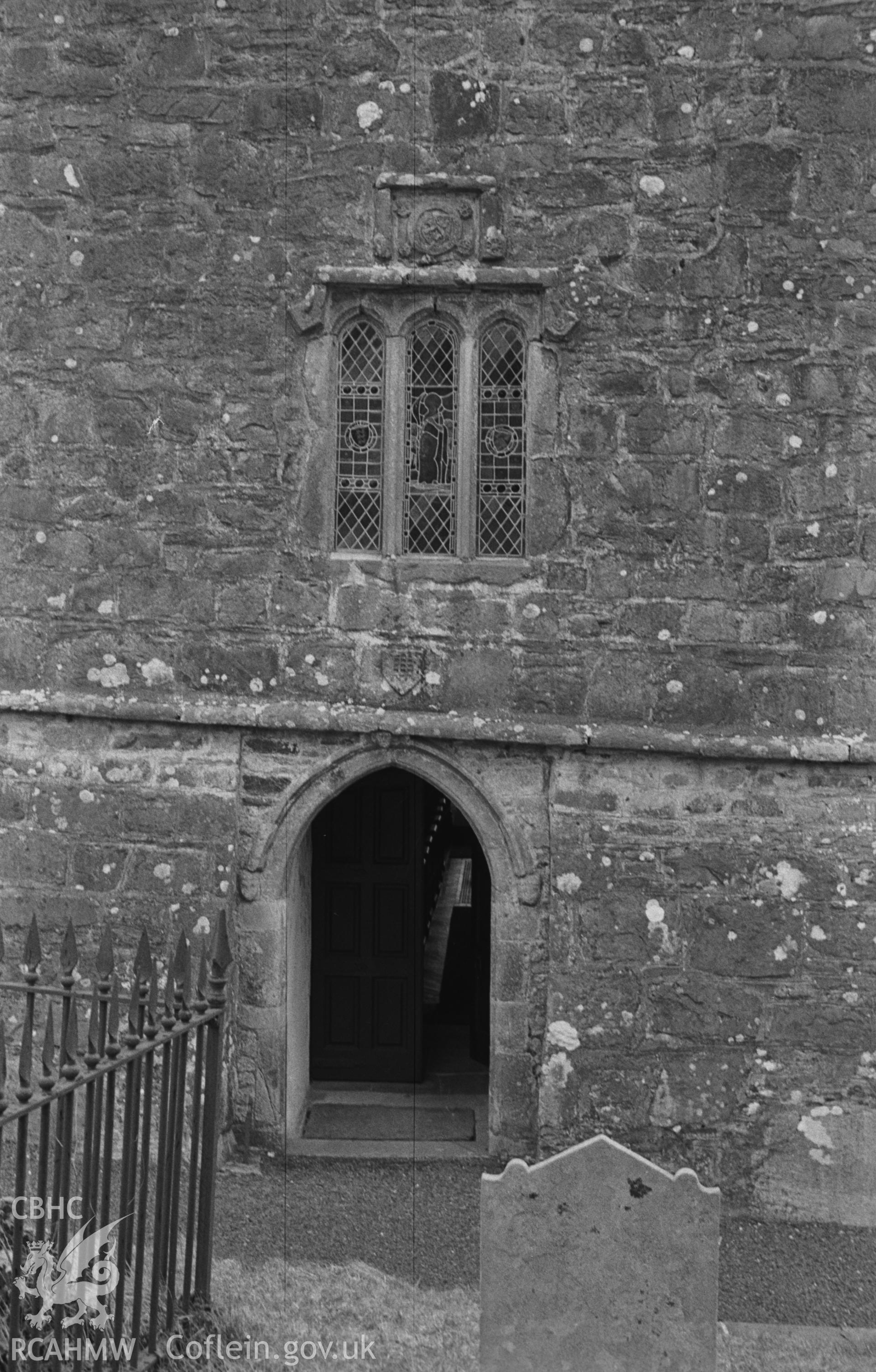Digital copy of a black and white negative showing west door and window of St Gwenog's church, Llanwenog, at the base of the tower. Photographed in April 1963 by Arthur O. Chater from Grid Reference SN 4937 4552, looking east.