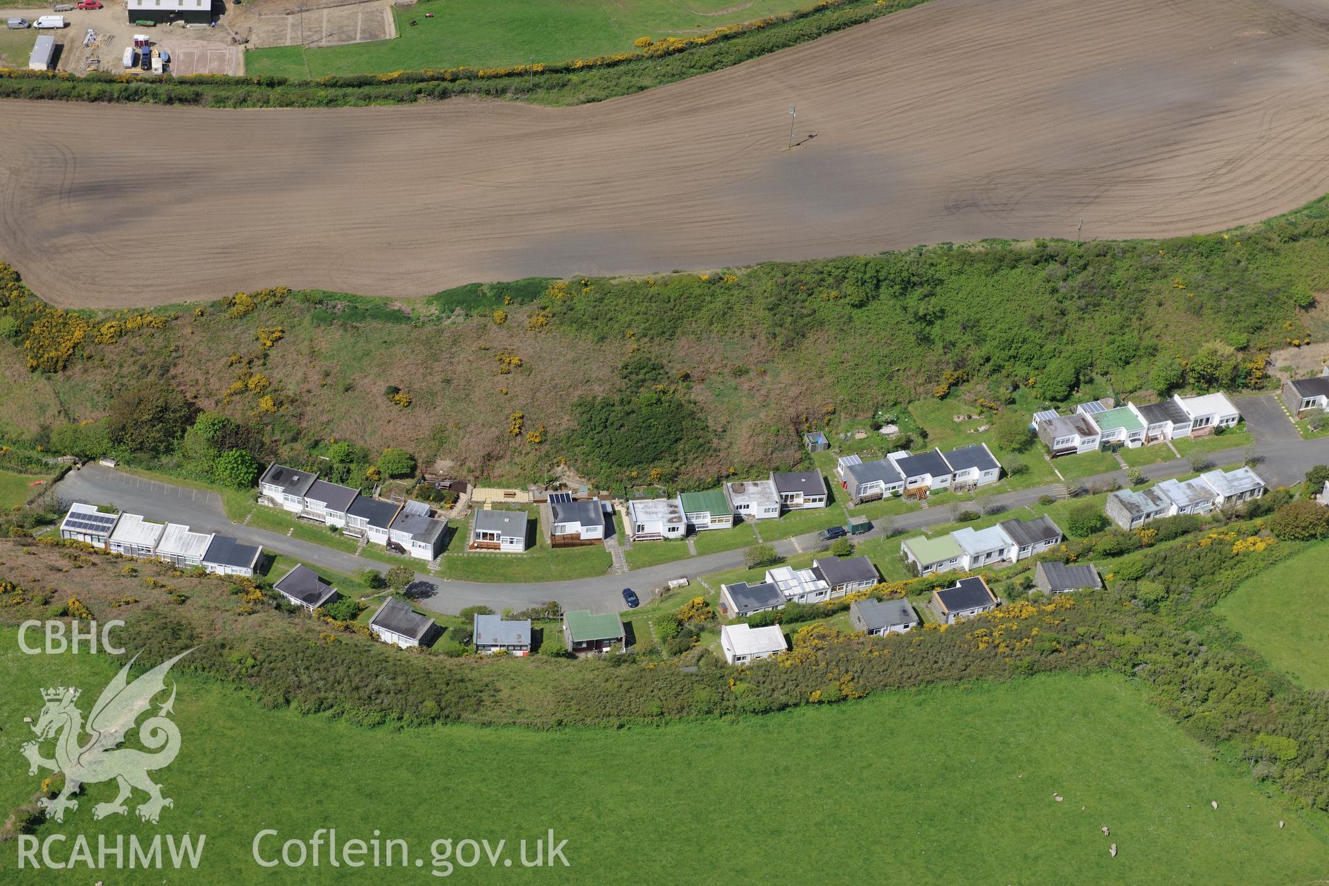 The village of Nolton Haven with soilmarks in field at Nolton Haven farm above.  Oblique aerial photograph taken during the Royal Commission's programme of archaeological aerial reconnaissance by Toby Driver on 13th May 2015.