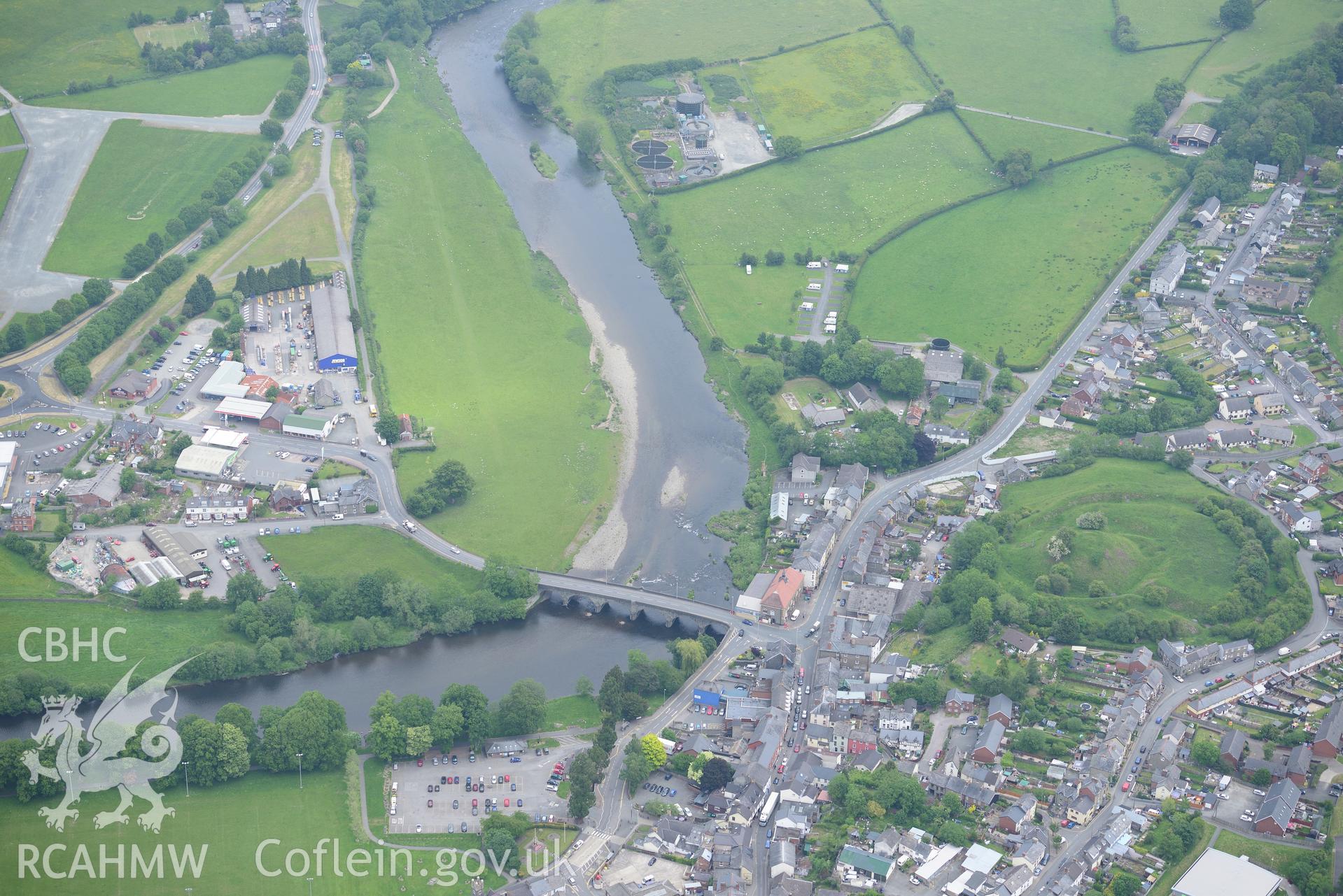 Builth Wells including views of Builth Castle, Builth Wells Market Hall and Builth bridge over the river Wye. Oblique aerial photograph taken during the Royal Commission?s programme of archaeological aerial reconnaissance by Toby Driver on 11th June 2015.