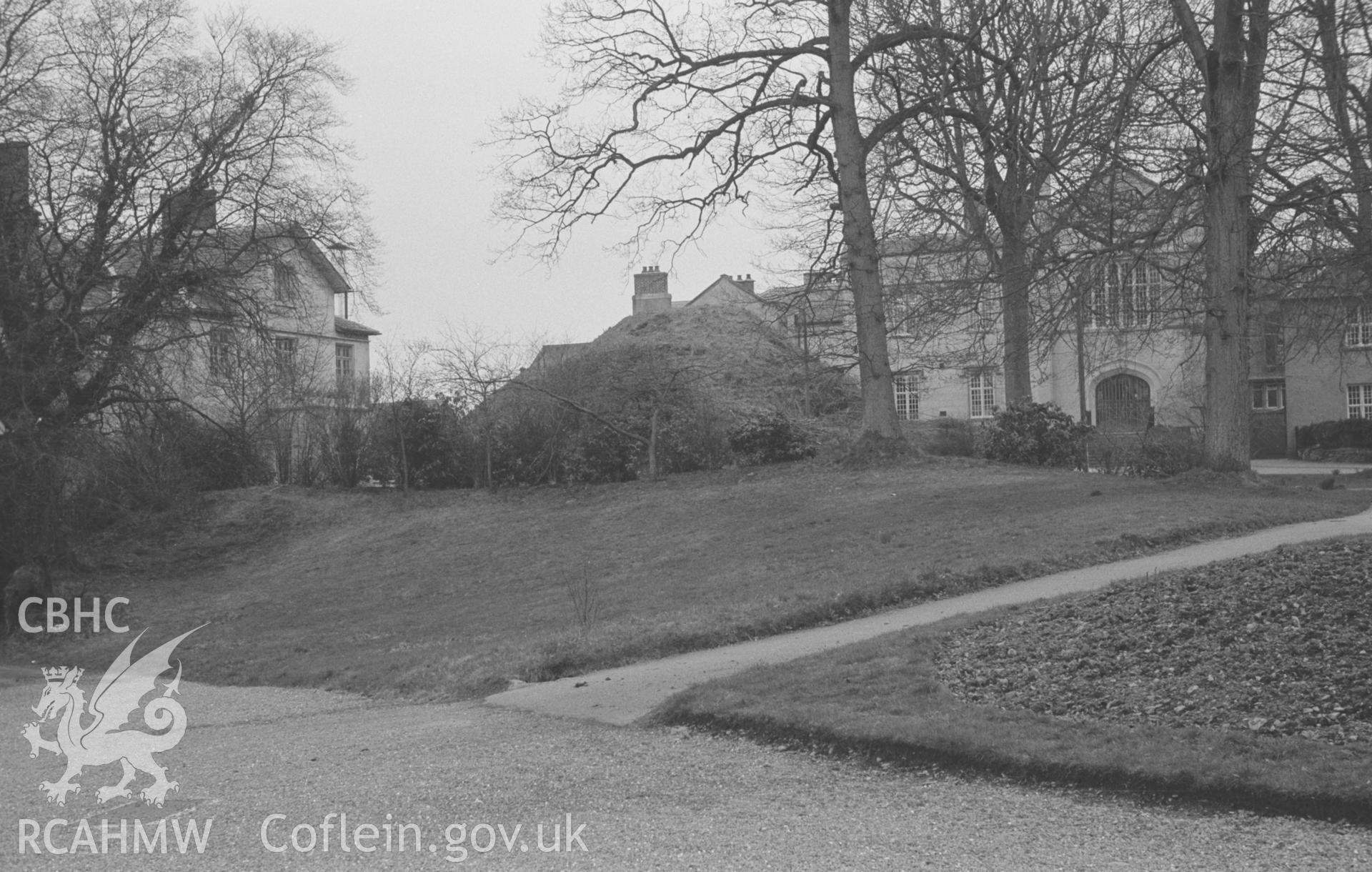 Digital copy of black & white negative showing Stephen's Castle motte with college school on left and main building of St. David's college on right, Lampeter. Photographed in March 1964 by Arthur O. Chater from Grid Ref SN 5791 4831, looking south east.