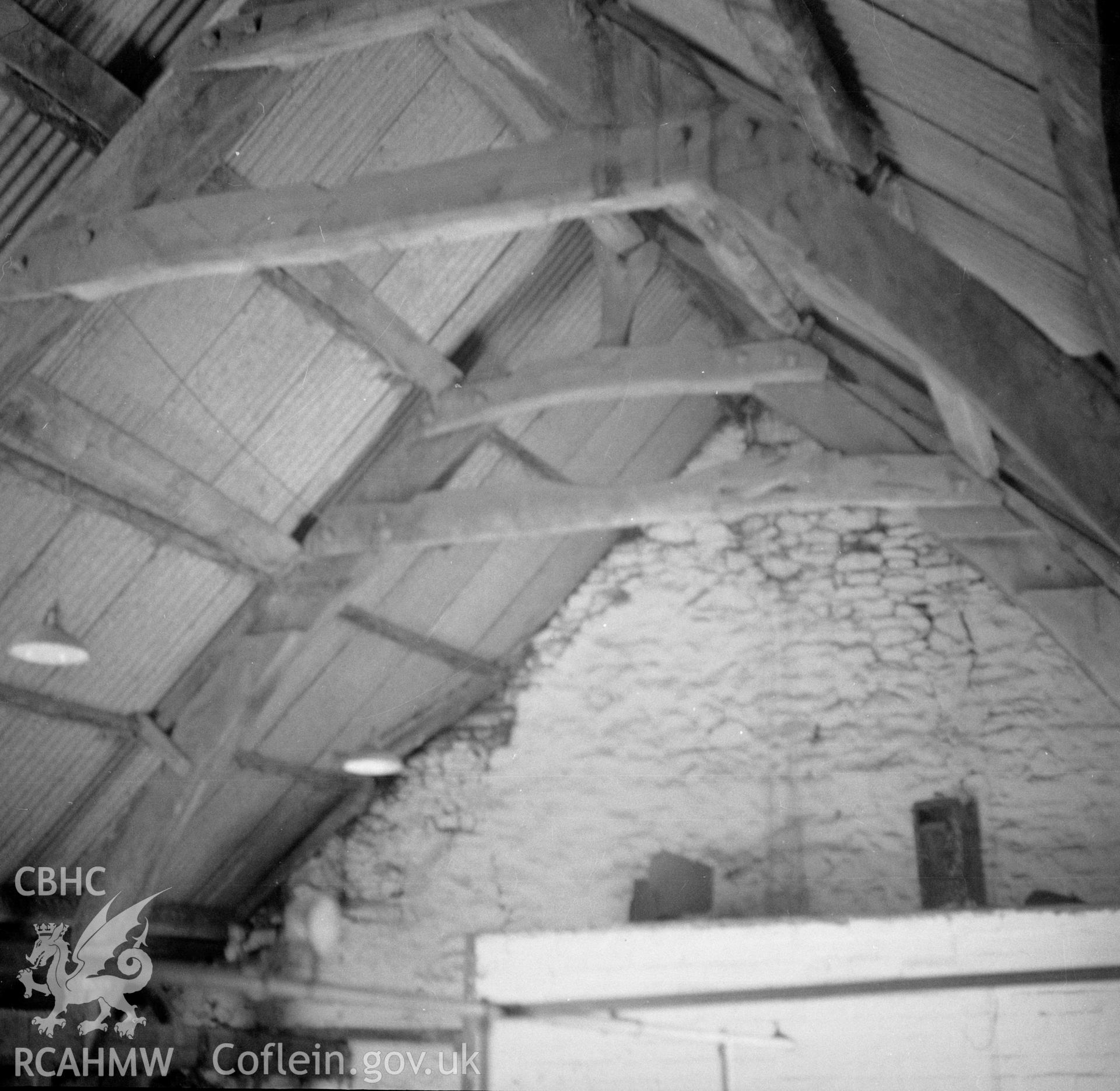 Digital copy of a nitrate negative showing interior view of the cruck barn at Maes y Rhiw, Llansadwrn.