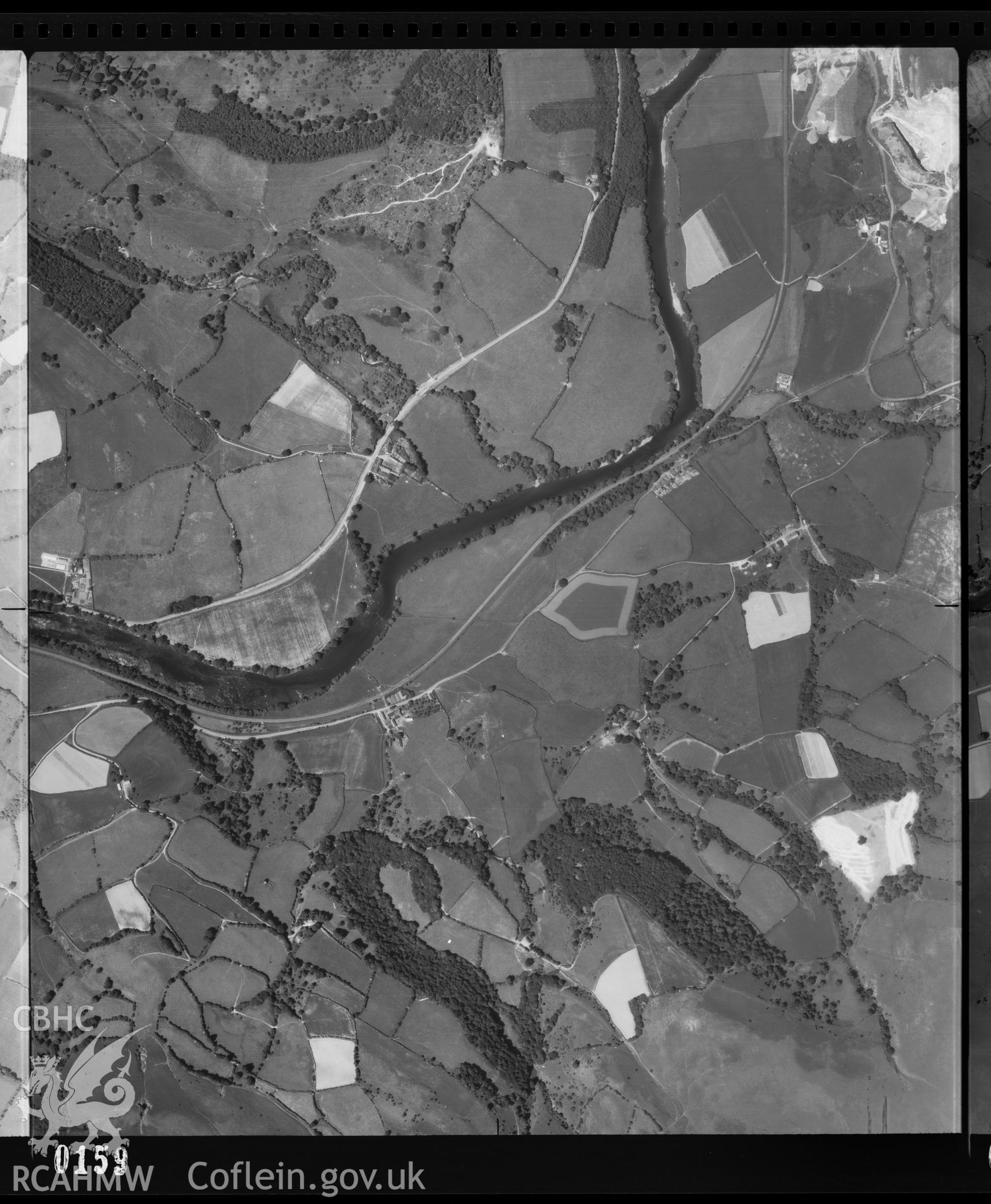 Digital copy of a black and white vertical aerial photograph taken by the RAF centred on SO0550 at a scale of 1:10000. The photograph includes part of Builth Wells community in Powys.