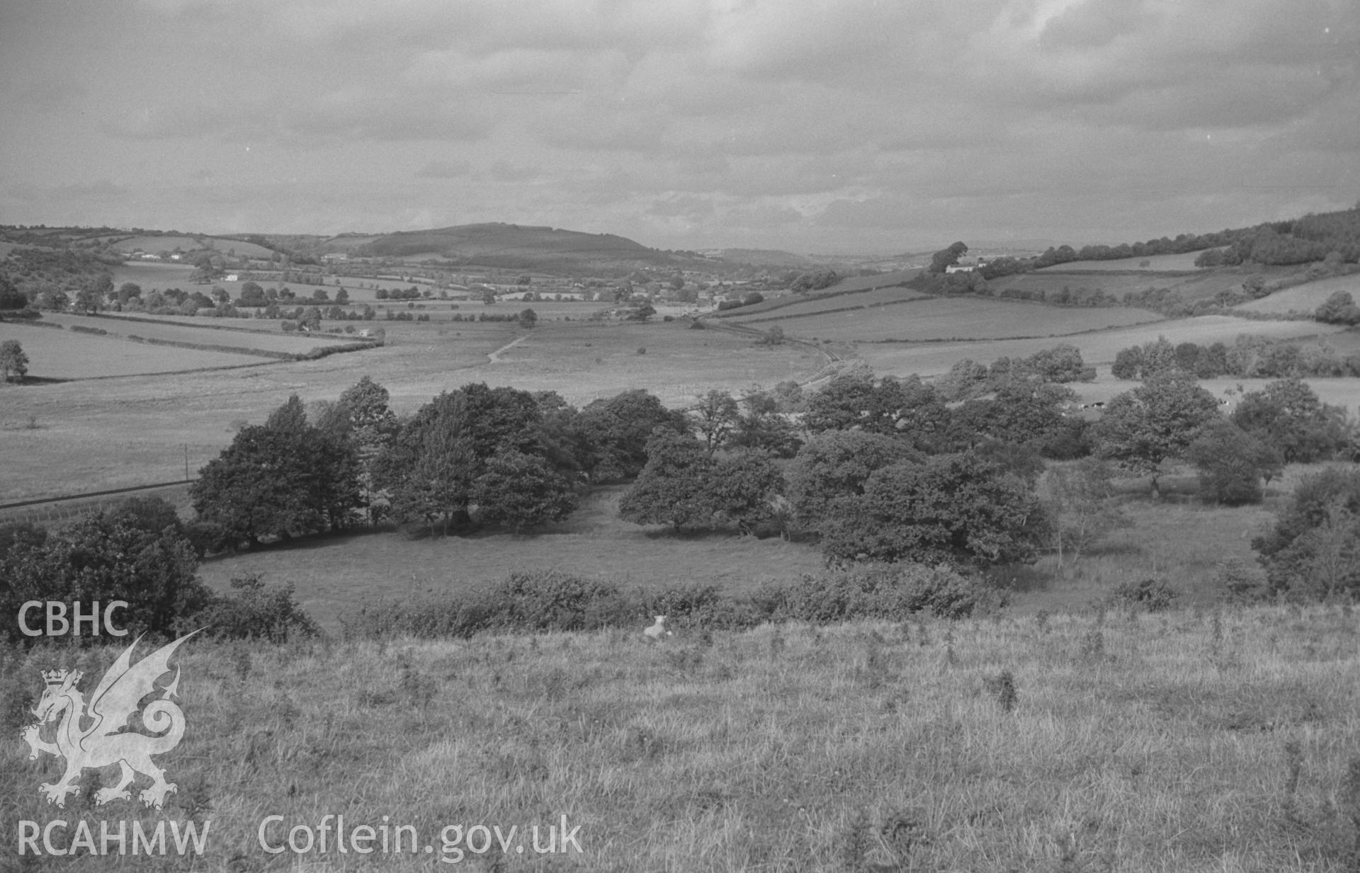 Digital copy of a black and white negative showing panoramic view of Glan Denys, Derry Ormond Monument, Dulas valley and woods by Castell Goetre. Photographed by Arthur O. Chater on 4th September 1966 from Grid Reference SN 591 505. (Photograph 2 of 6).