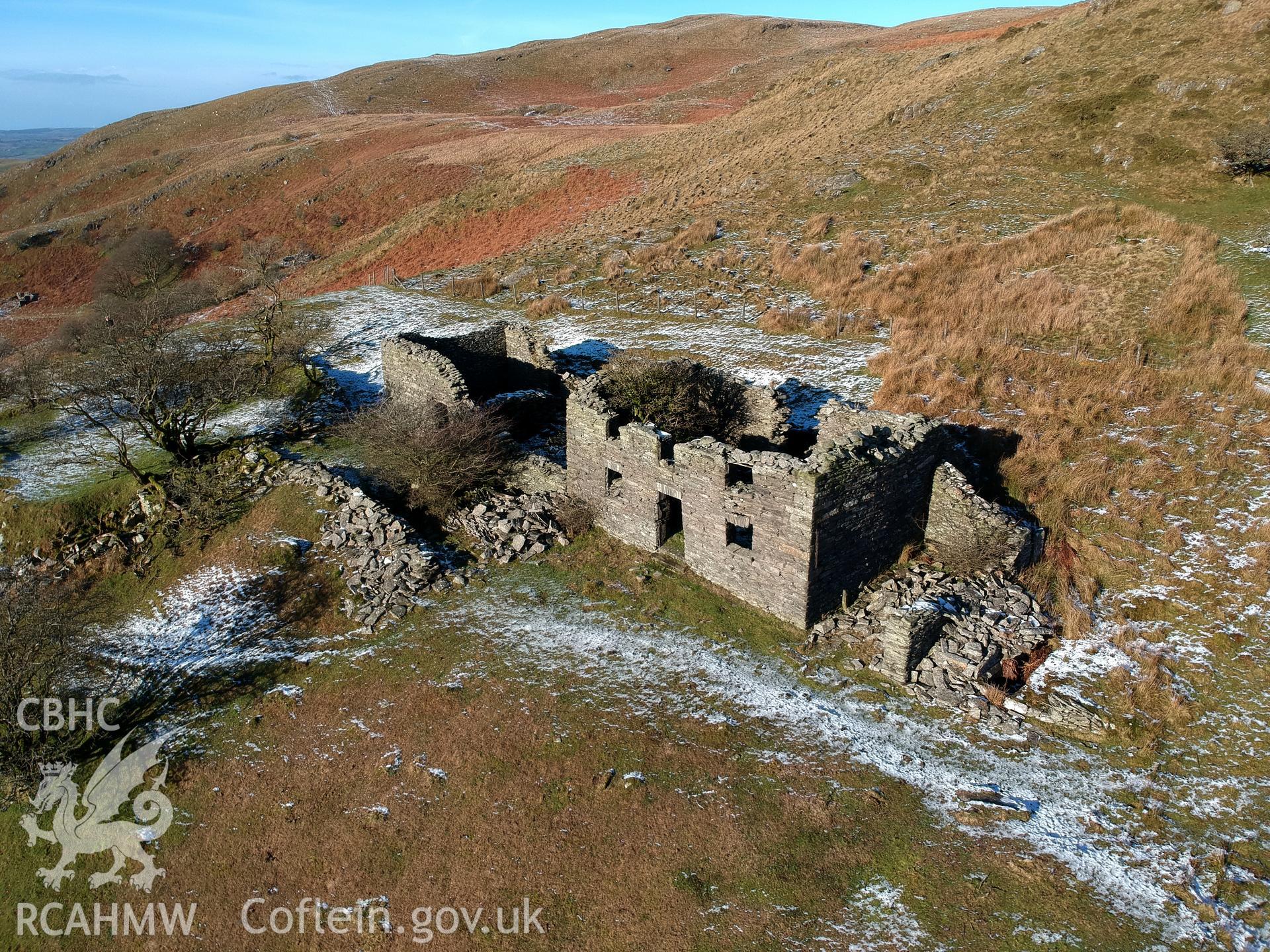 Detailed aerial view showing exterior front elevation of deserted, roofless, dry-stone walled Ty-Canol house at Ty-Canol farmstead, Creigen Ddu. Colour photograph taken by Paul R. Davis on 17th January 2019.