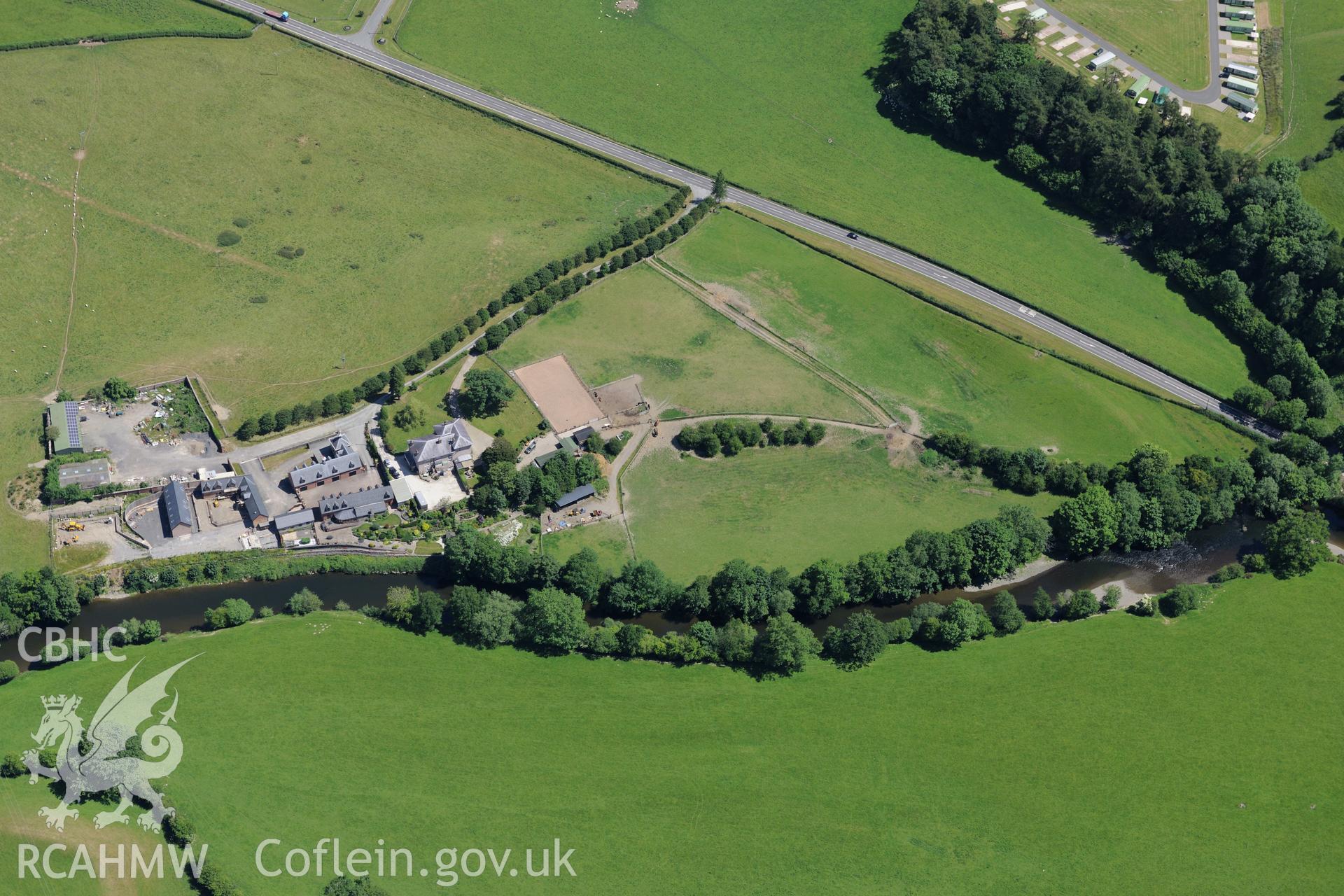 Glanhafren house and garden, and the Roman road which runs through its grounds, west of Newtown. Oblique aerial photograph taken during the Royal Commission's programme of archaeological aerial reconnaissance by Toby Driver on 30th June 2015.