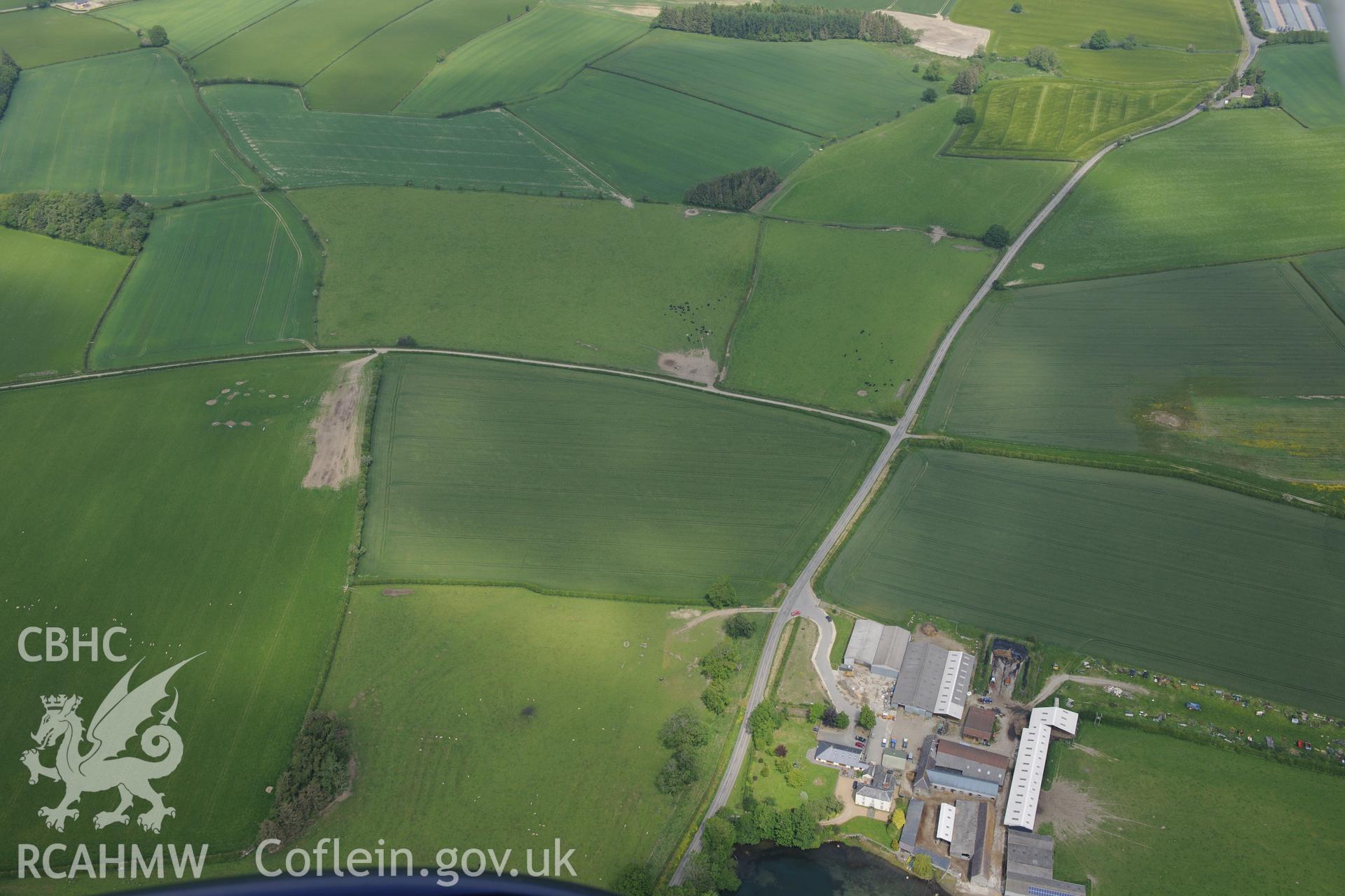 Hindwell Farmstead near Old Radnor. Site of Roman fort; Roman Camp; a palisaded enclosure and Hindwell Farm Barrows. Oblique aerial photograph taken during the Royal Commission's programme of archaeological aerial reconnaissance by Toby Driver on 11th June 2015.