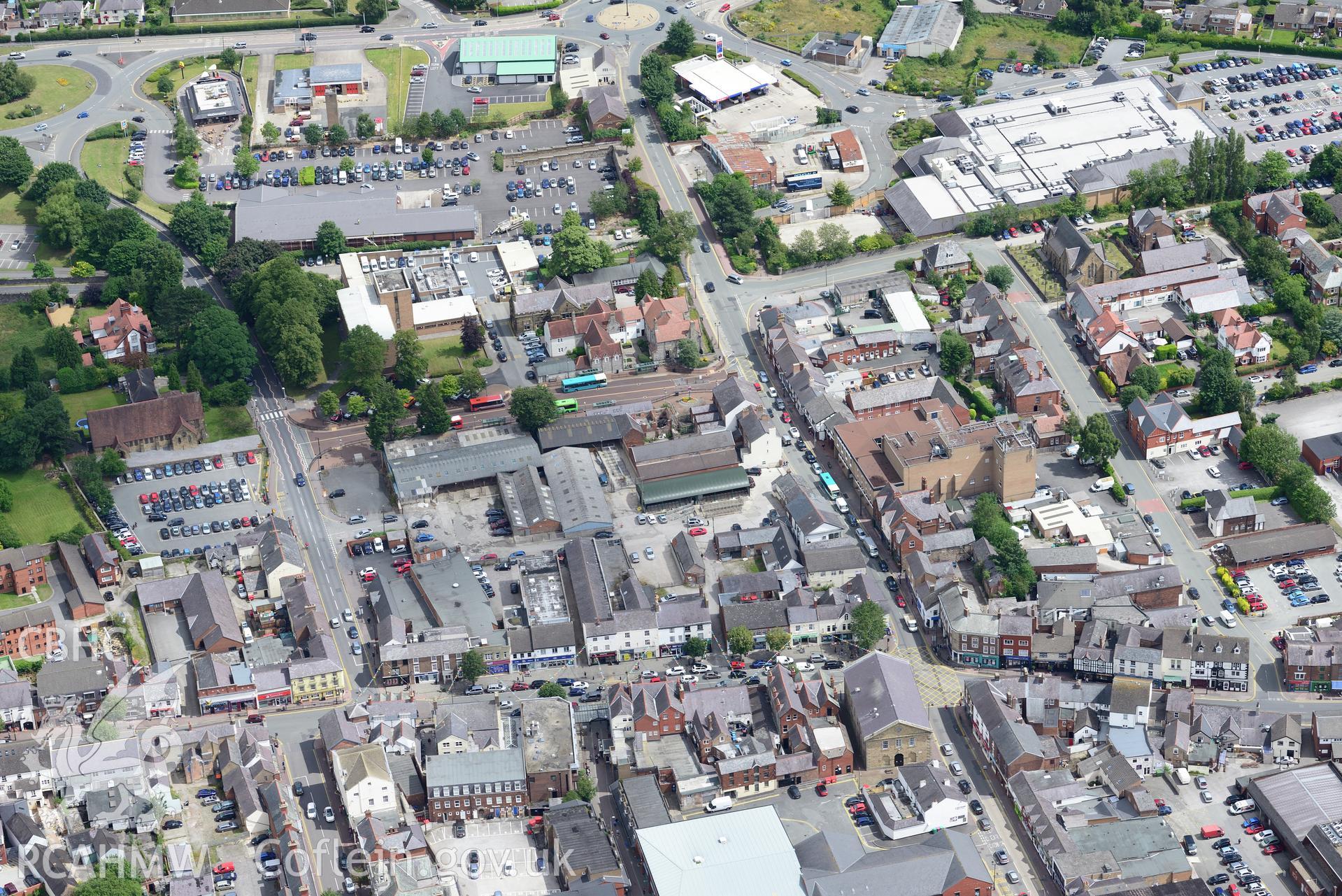 Mold county hall, railway station, Lloyd's TSB bank, Methodist Chapel and Sunny Bank, Mold. Oblique aerial photograph taken during the Royal Commission's programme of archaeological aerial reconnaissance by Toby Driver on 30th July 2015.