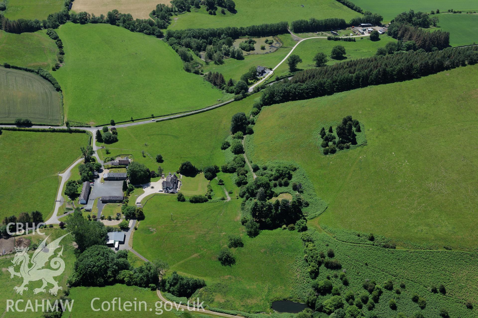 Pilleth Court, the associated farm complex and buildings. Site of the battle at Bryn Glas also visible. Oblique aerial photograph taken during the Royal Commission's programme of archaeological aerial reconnaissance by Toby Driver on 30th June 2015.