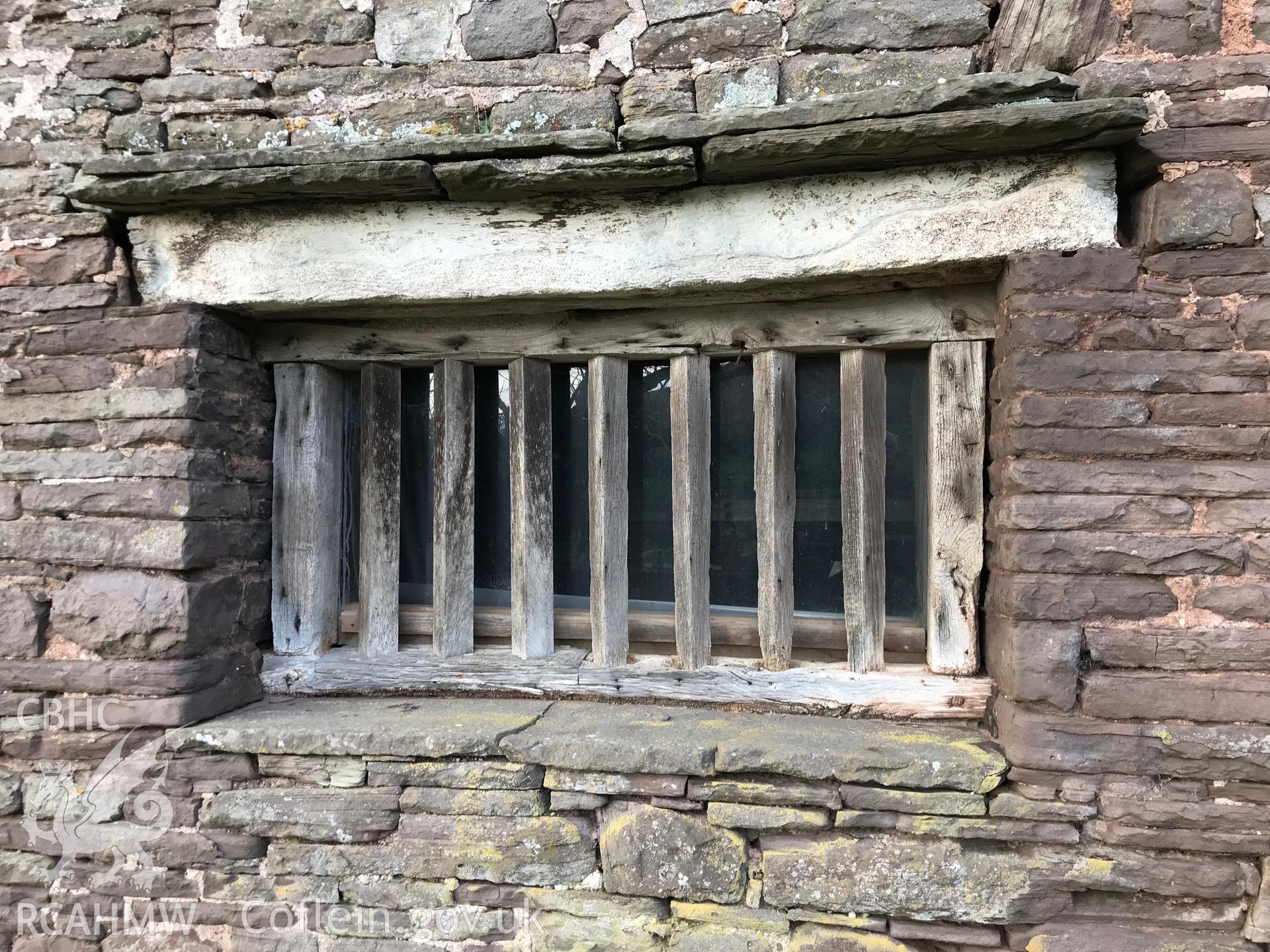 Exterior view showing detail of wooden barred window at Ty-Hwnt-y-Bwlch, Crucorney. Colour photograph taken by Paul R. Davis on 1st January 2019.