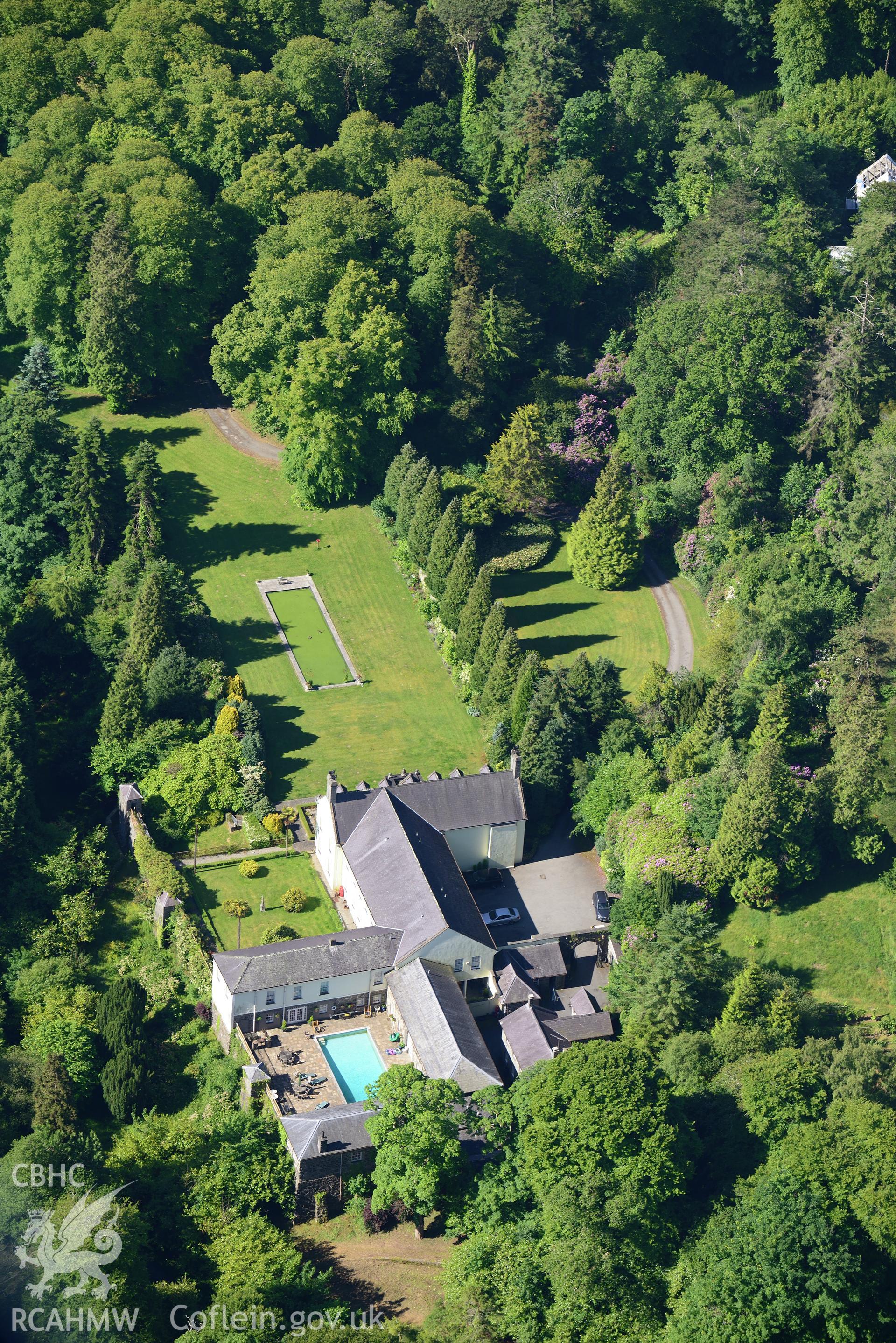 Plas Boduan surrounded by its park and gardens. Oblique aerial photograph taken during the Royal Commission's programme of archaeological aerial reconnaissance by Toby Driver on 23rd June 2015.
