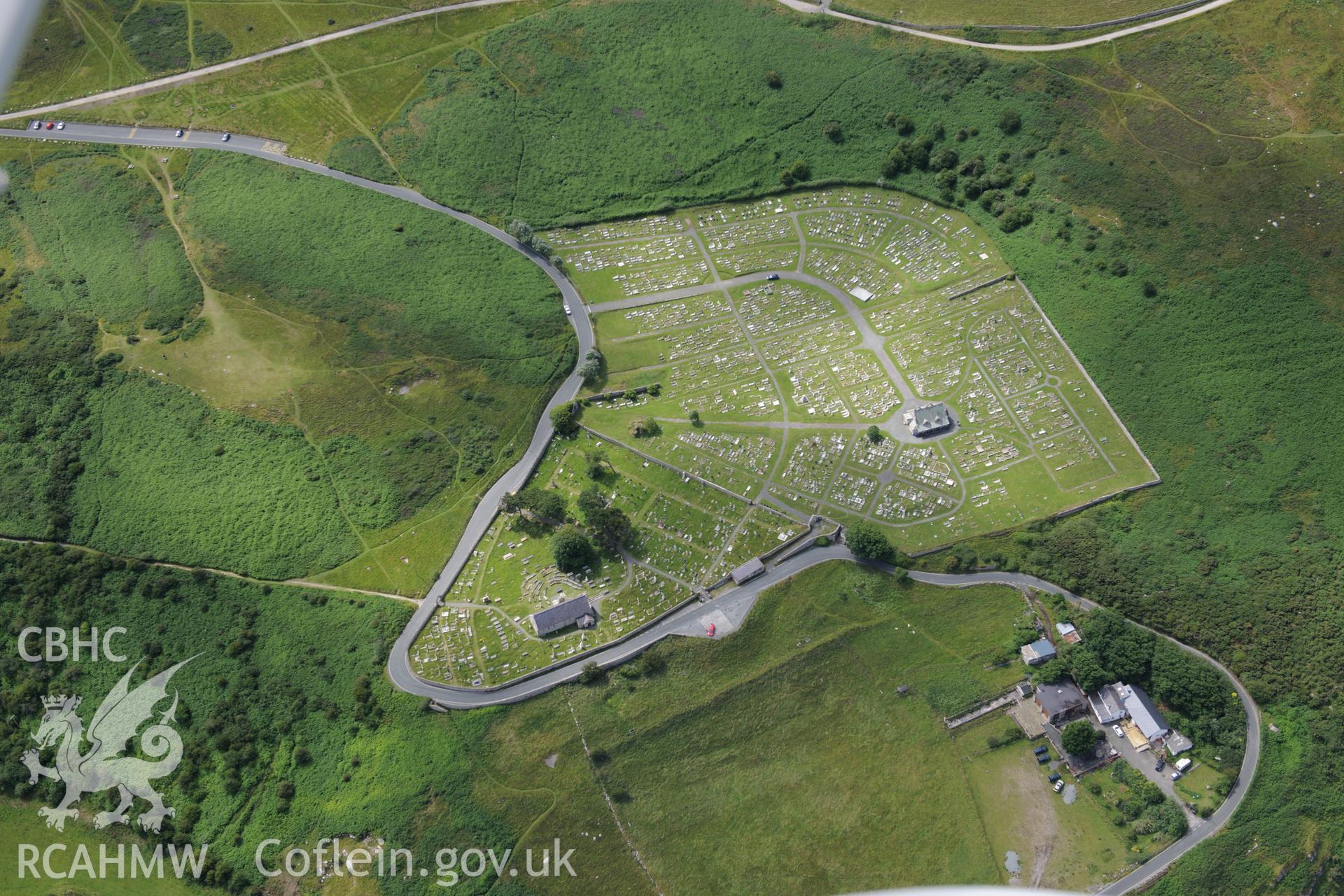The Great Orme, Llandudno, including views of St. Tudno's church and well, cemetery, rectory and garden, and the foundations of long huts. Oblique aerial photograph taken during the Royal Commission's programme of archaeological aerial reconnaissance by Toby Driver on 30th July 2015.