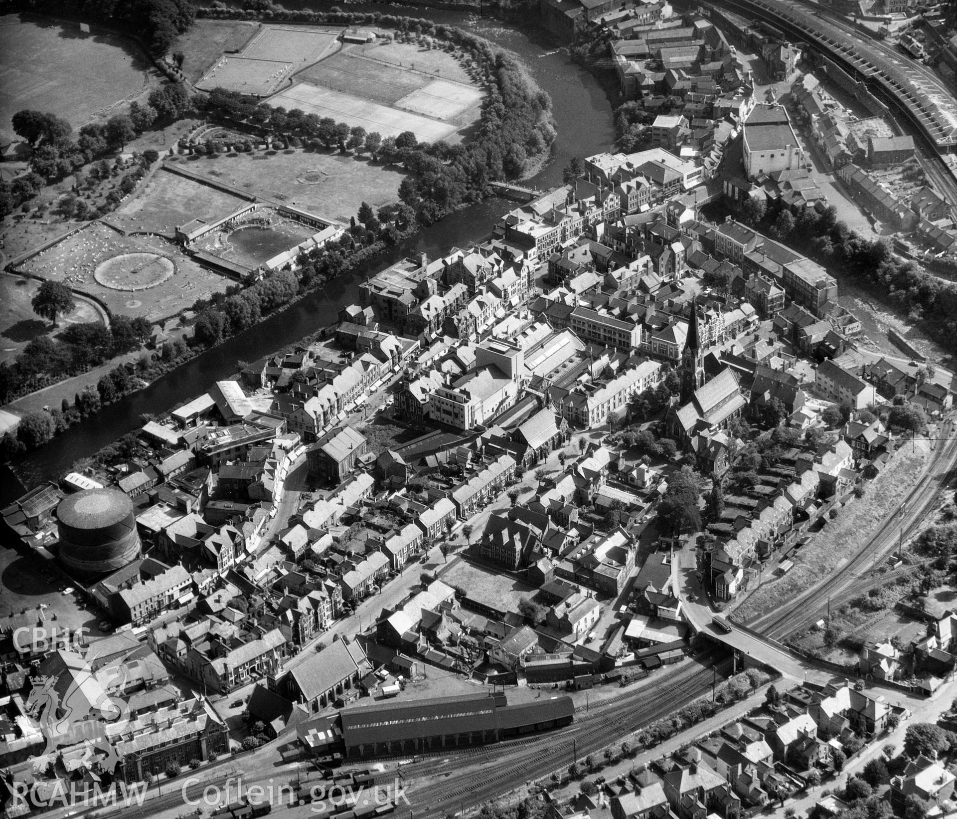 Digital copy of a black and white oblique aerial photograph showing Pontypridd Town Centre, taken by Aerofilms Ltd, 1955.