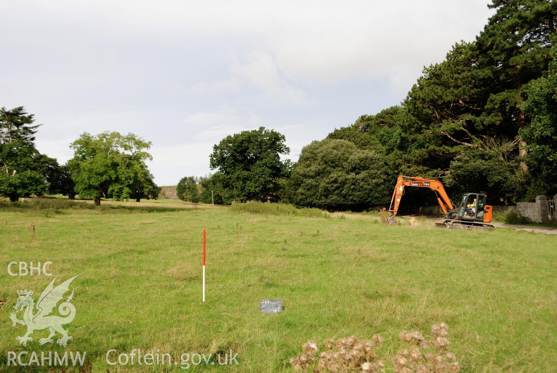 Wide angle view from east of evaluation area pre-excavation, with garden boundary wall to the north. Photographed during archaeological evaluation of Kinmel Park, Abergele, conducted by Gwynedd Archaeological Trust on 22nd August 2018. Project no. 2571.