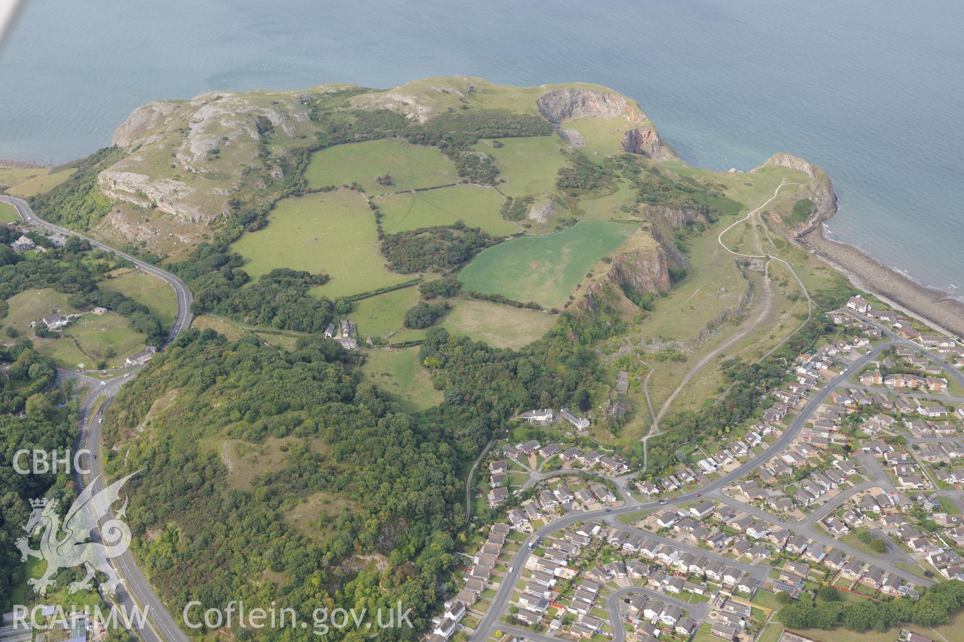 Penrhyn Bay and Little Ormes Head quarry. Oblique aerial photograph taken during the Royal Commission's programme of archaeological aerial reconnaissance by Toby Driver on 11th September 2015.