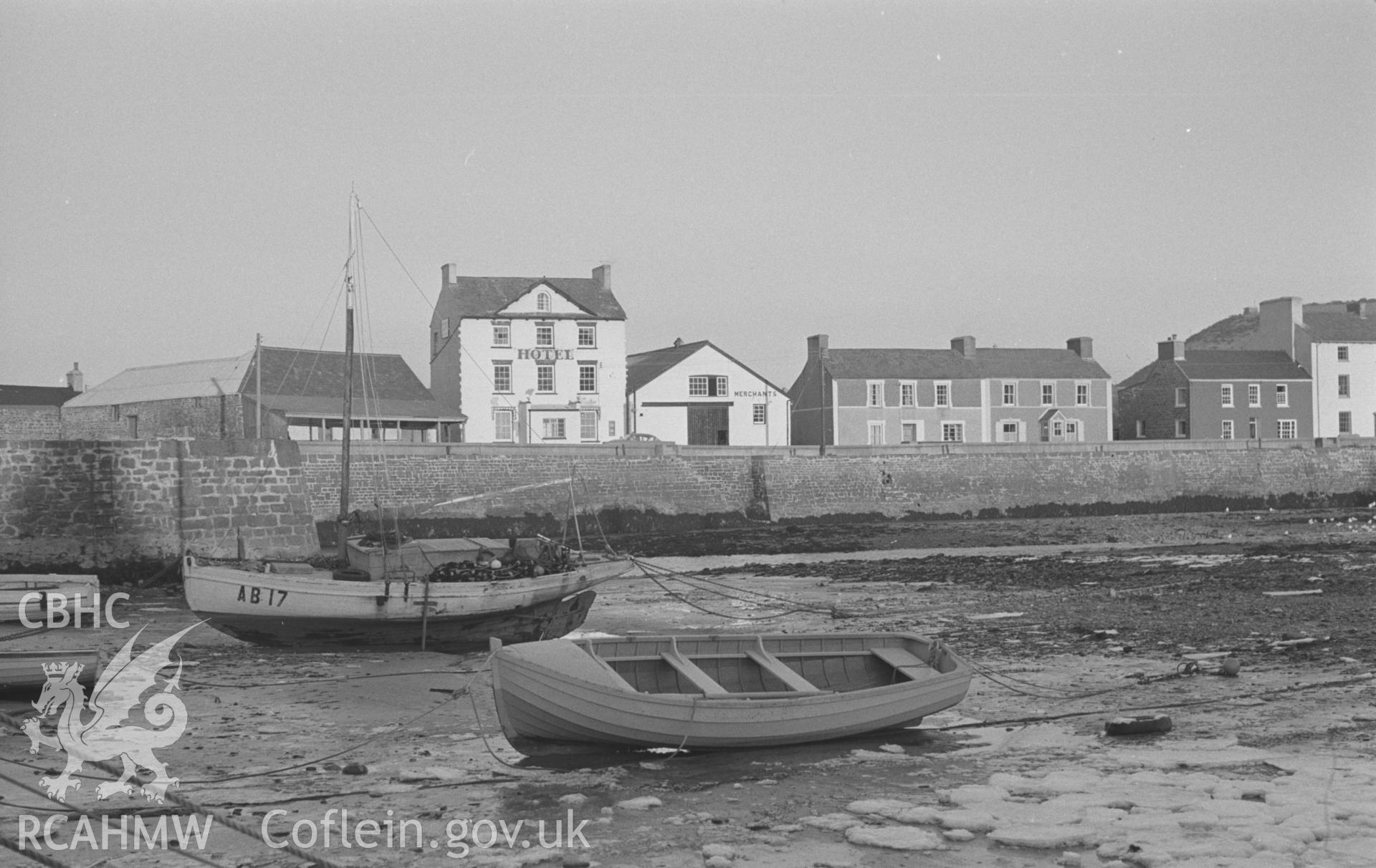 Black and White photograph showing the Harbourmaster Hotel from across the lower end of the harbour at Aberaeron. Photographed by Arthur Chater in December 1962, from Grid Reference SN 4546 6293, looking east north-east.