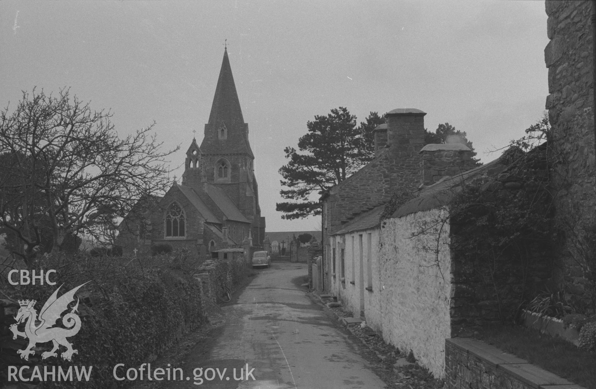 Black and White photograph showing view down the lane to St. Rhystud's church, and cottages at Llanrhystud. Photographed by Arthur Chater in April 1962 from Grid Reference SN 538 697, looking west.