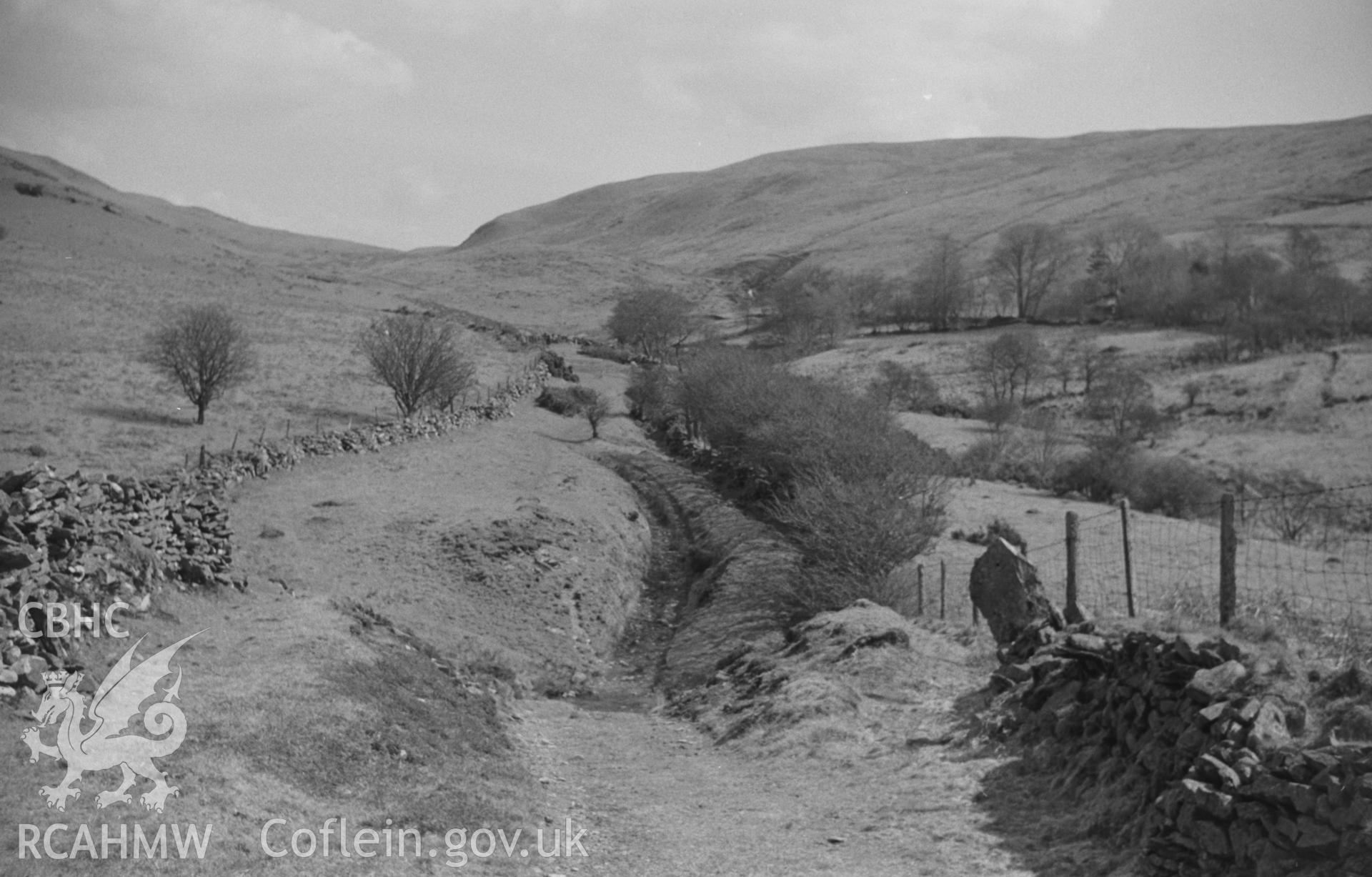 Black and White photograph showing view up the old track between high banks at 925ft. Photographed by Arthur Chater in April 1962 from Grid Reference SN 720 604, looking south east.