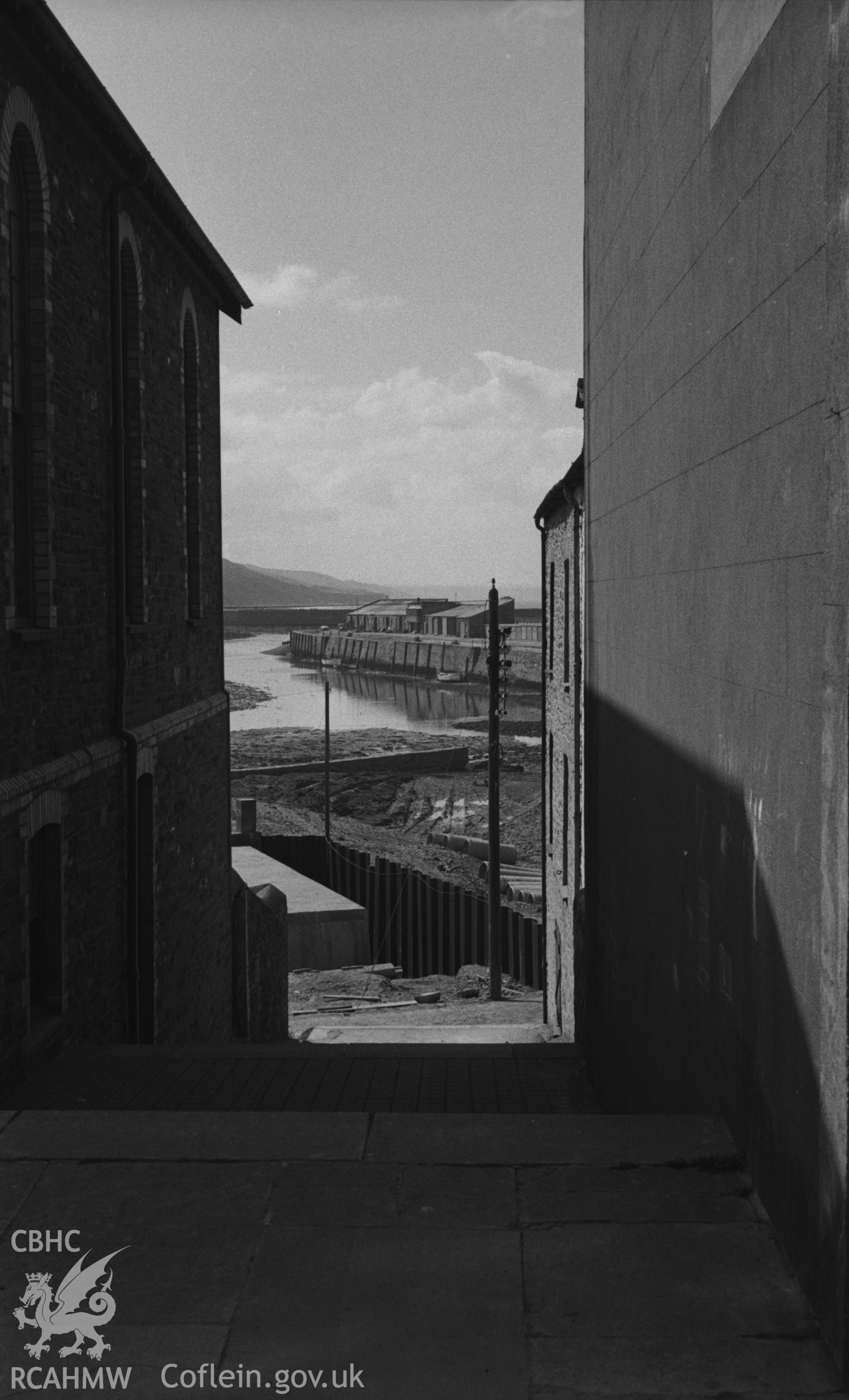 Black and White photograph showing the harbour, looking down the steps between Rheidol Place and Tan-y-Cae Sunday School, South Road. Photographed by Arthur Chater in March 1961, from Grid Reference SN 5816 8140. looking south south-west.