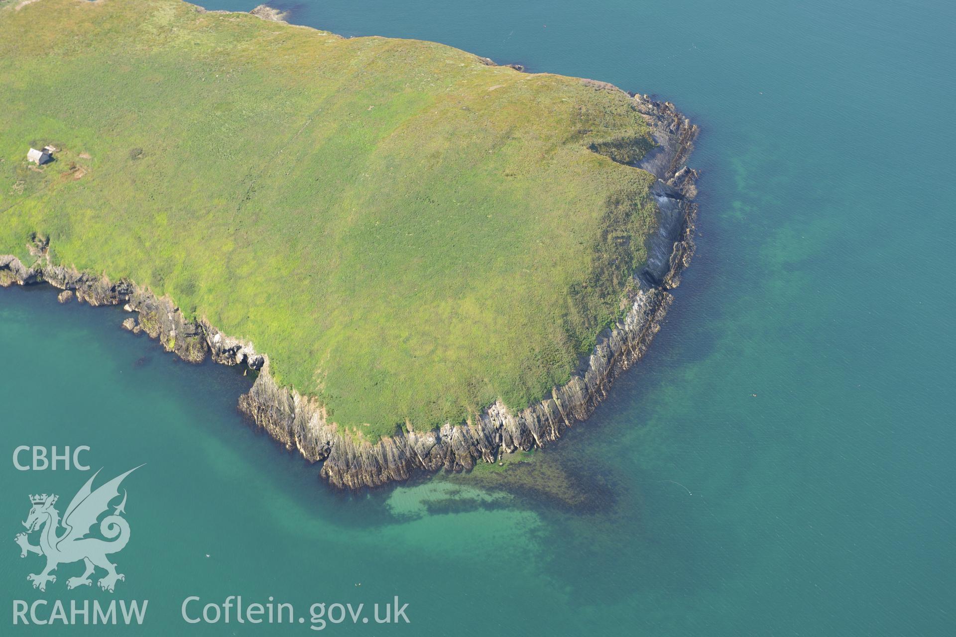 Chapel buildings; footings of priory hall and fish trap at St Tudwal's Island (east). Oblique aerial photograph taken during the Royal Commission's programme of archaeological aerial reconnaissance by Toby Driver on 23rd June 2015.