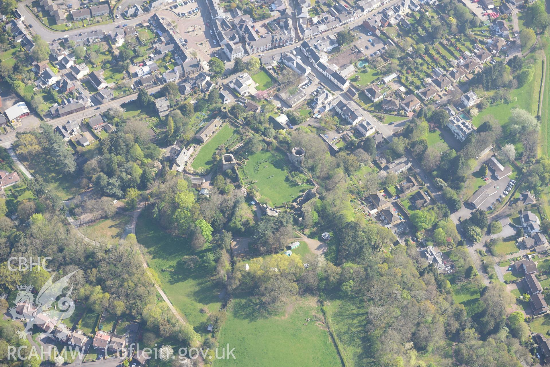 Usk Town including the Castle and it's house, garden and barn. Oblique aerial photograph taken during the Royal Commission's programme of archaeological aerial reconnaissance by Toby Driver on 21st April 2015