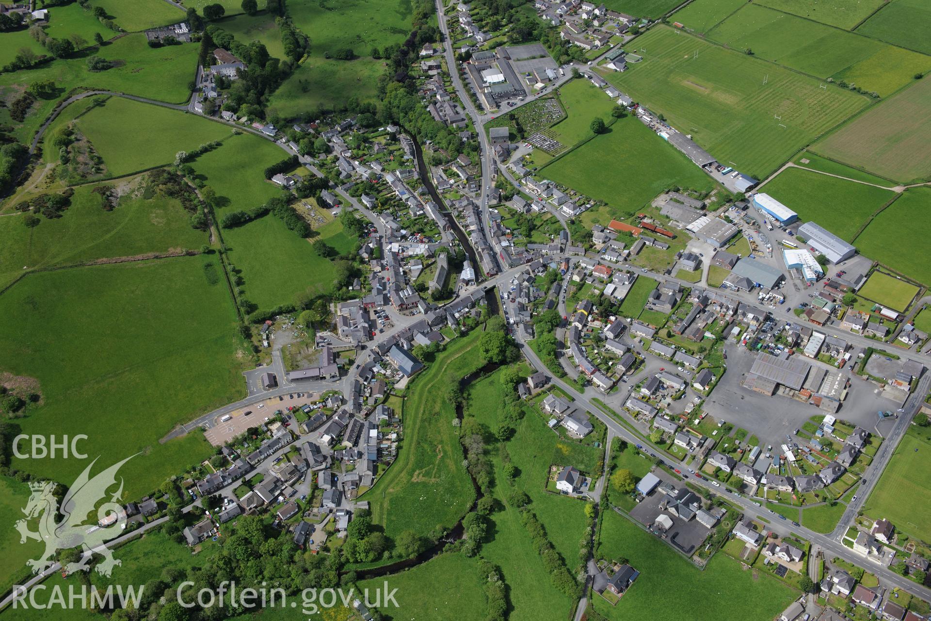 Tregaron town with Tregaron bridge in centre of photograph. Oblique aerial photograph taken during the Royal Commission's programme of archaeological aerial reconnaissance by Toby Driver on 3rd June 2015.