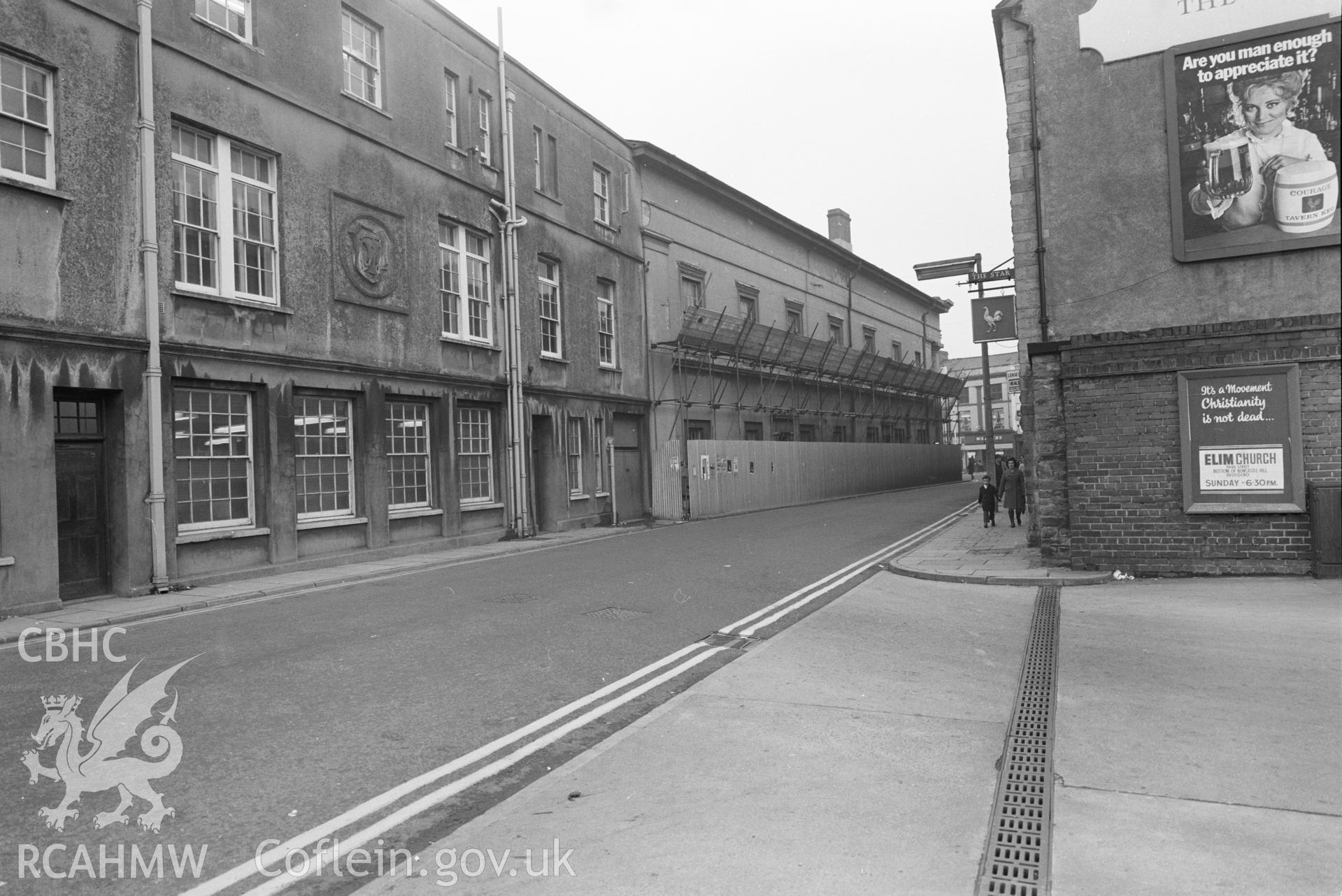 Digital copy of a black and white negative showing view of street in Bridgend.