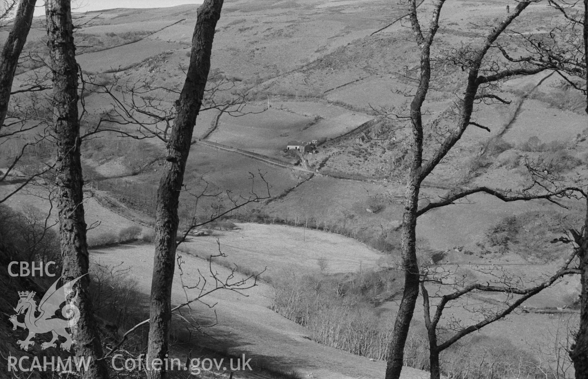 Digital copy of black & white negative showing view 350m north north west of Pendinas (where Nant-y-Ffr?d enters Coed-Pen-y-Bontbren-Uchaf - SN67538805) across Leri valley to Cerrig-Mawr Farm. Photograph by Arthur Chater, April 1963, looking north west.