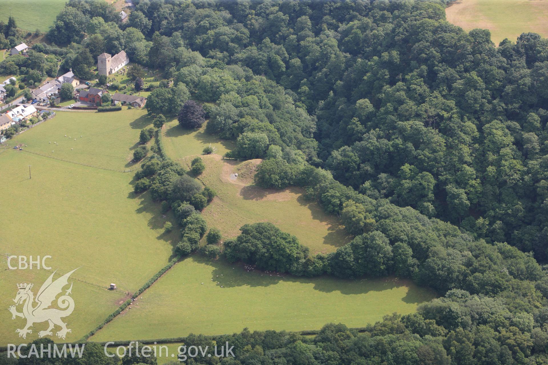 Aberedw Castle Mound with St. Cewydd's Church to the north east, south east of Builth Wells. Oblique aerial photograph taken during the Royal Commission?s programme of archaeological aerial reconnaissance by Toby Driver on 1st August 2013.