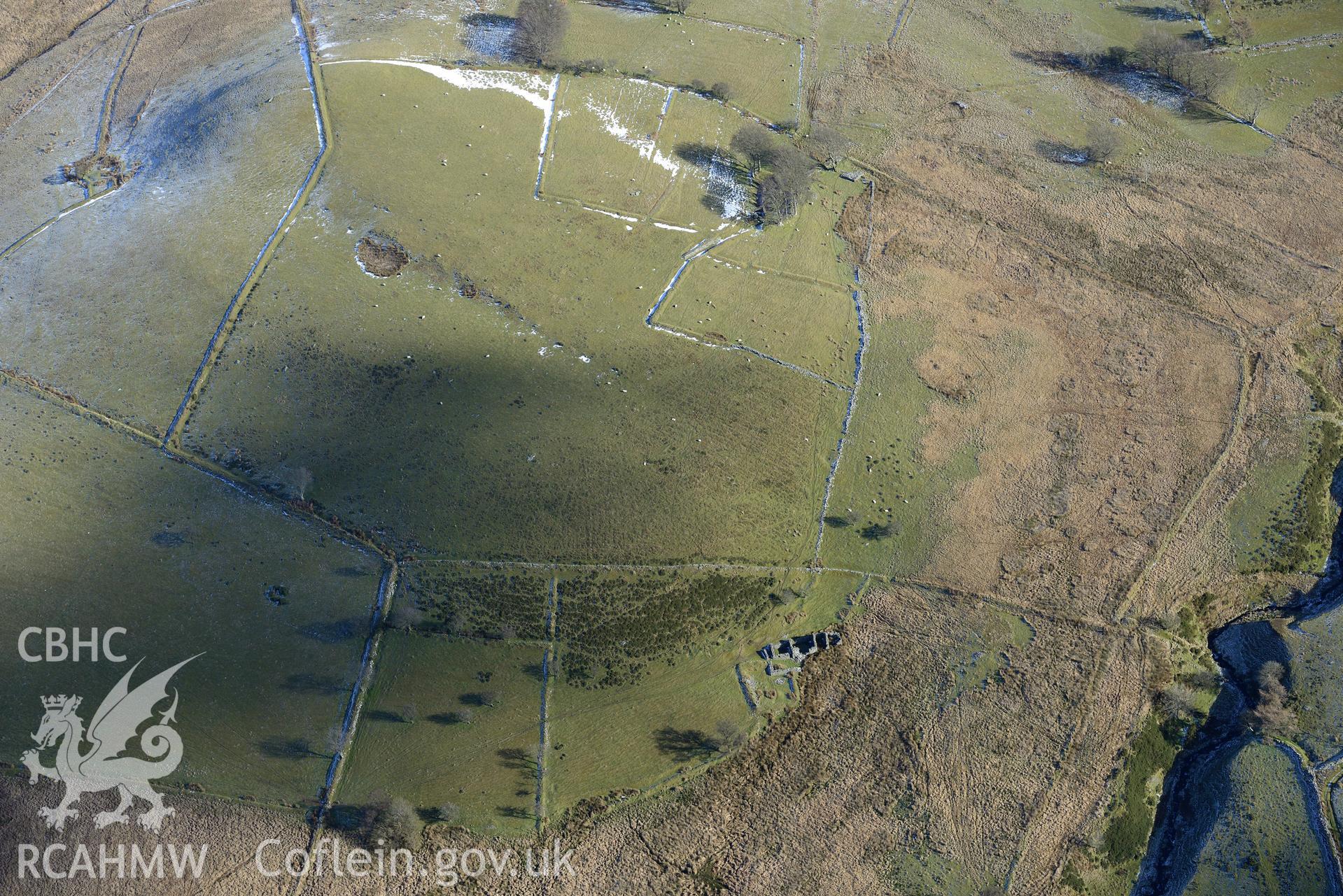 Area of deserted farmsteads at Gwar Ffynnon, including ruins of Ochr Bryn Lloi farmhouse, east of Tregaron. Oblique aerial photograph taken during the Royal Commission's programme of archaeological aerial reconnaissance by Toby Driver on 4th February 2015.