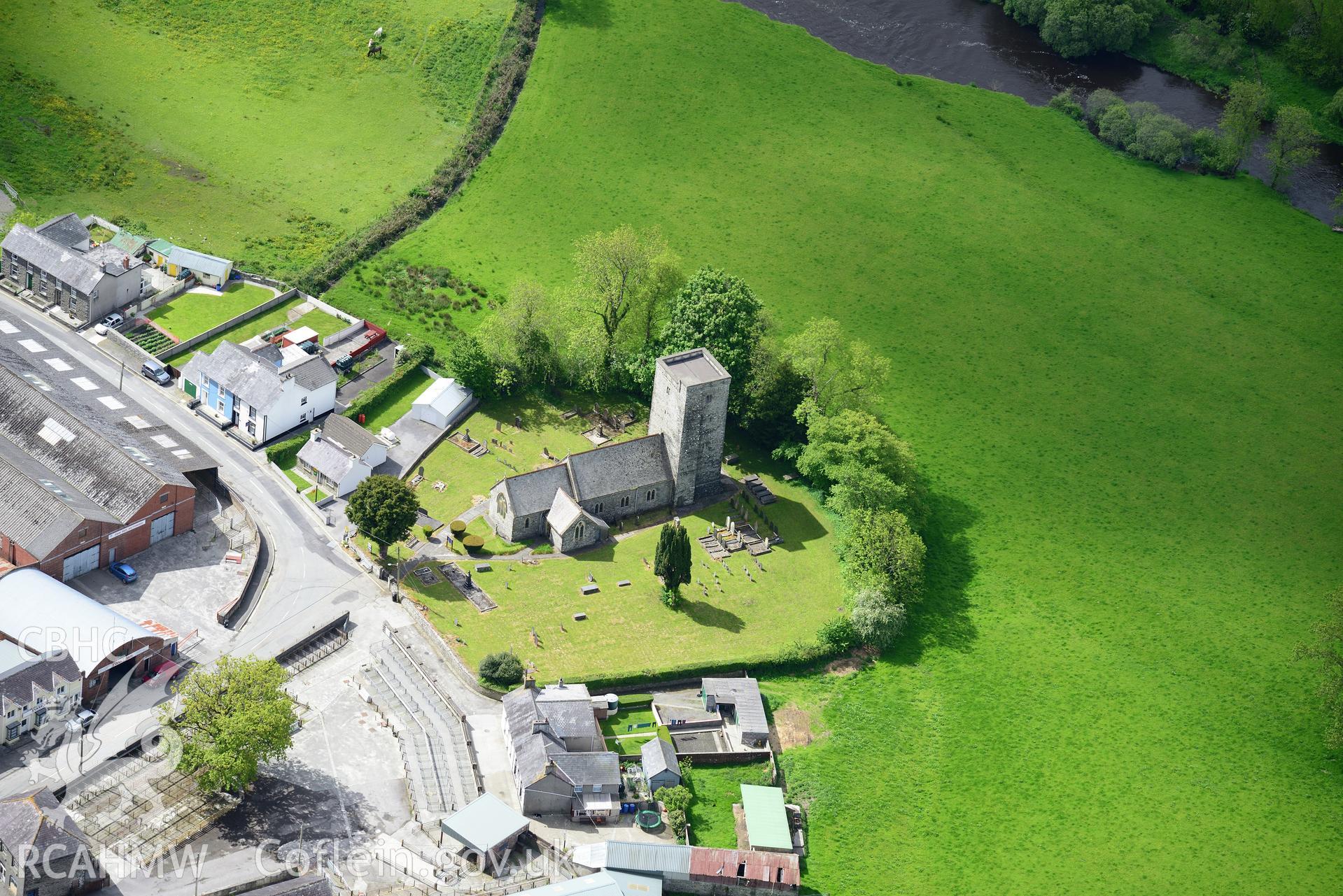 St. Peter's Church and part of Llanybydder Livestock Market, Llanybydder. Oblique aerial photograph taken during the Royal Commission's programme of archaeological aerial reconnaissance by Toby Driver on 3rd June 2015.